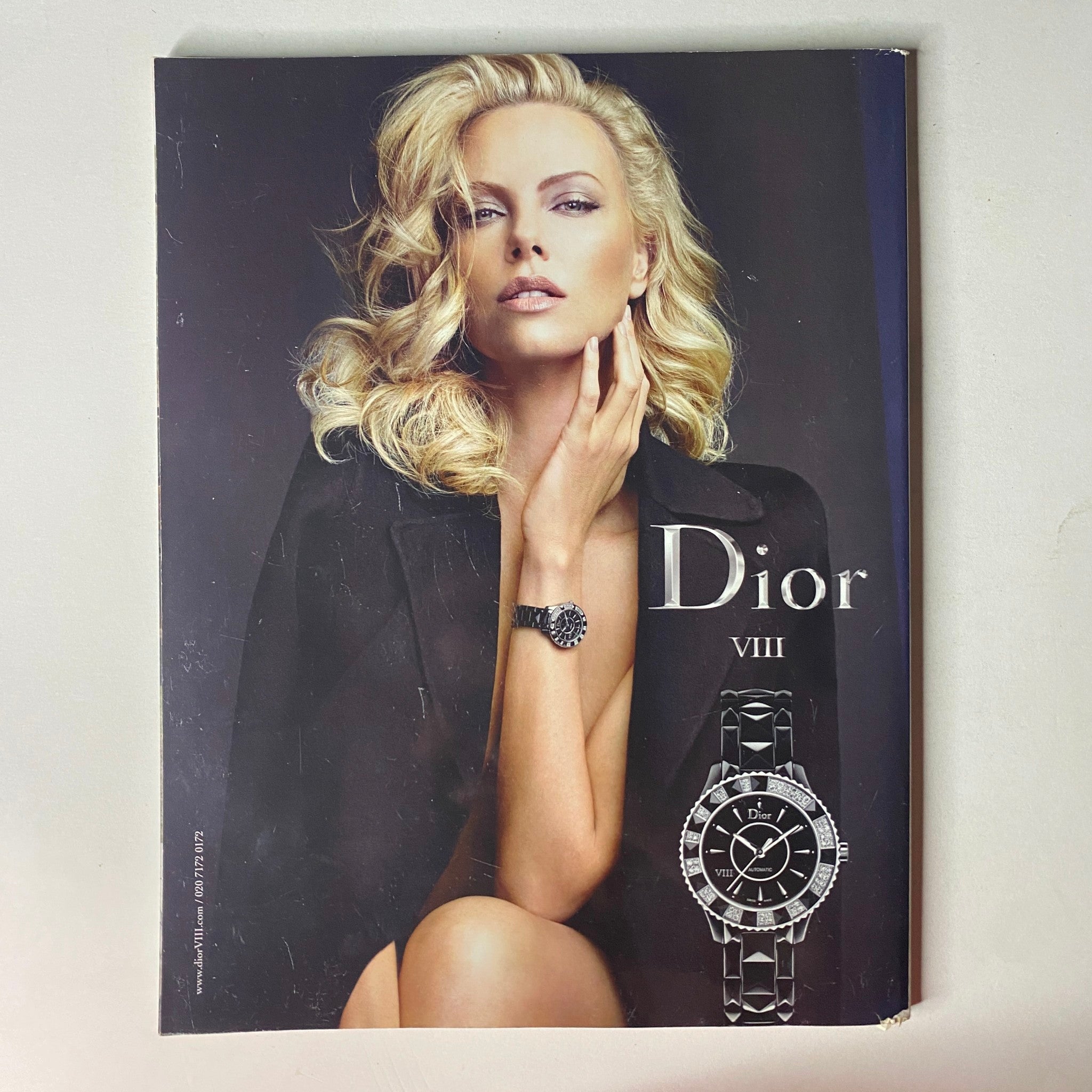 Dior advertisement showcasing a glamorous watch alongside a portrait of a stylish blonde woman, from Vogue British Magazine July 2011 Vanessa Paradis Cover No Label VG.