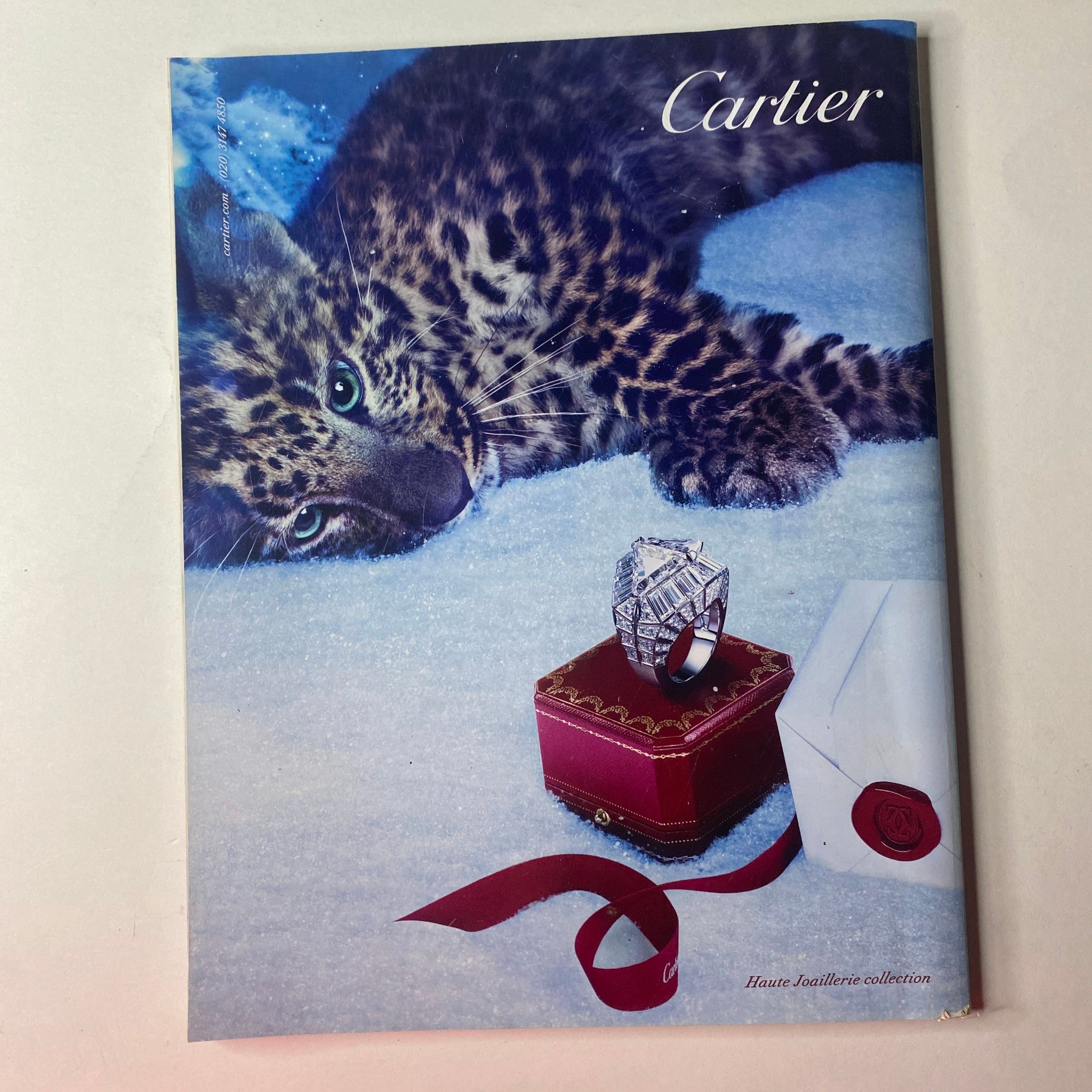 Cover of Cartier Haute Joaillerie collection featured in Vogue British Magazine January 2013, featuring a leopard and elegant jewelry photography.