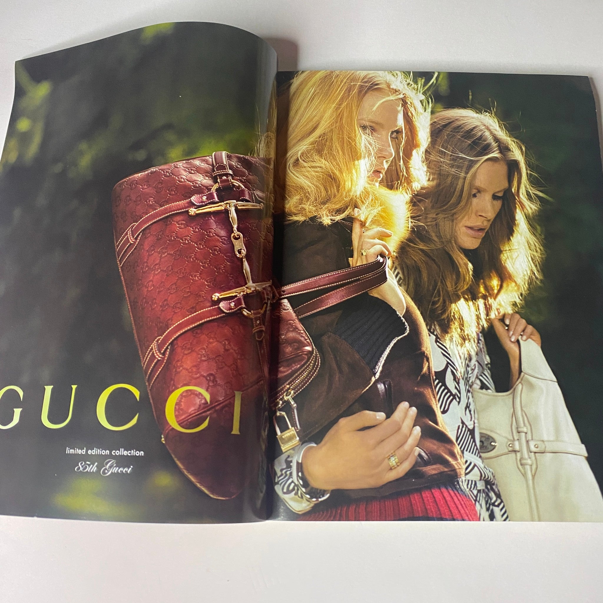 Gucci advertisement spread from Vogue British Magazine August 2006, featuring models showcasing limited edition handbags.