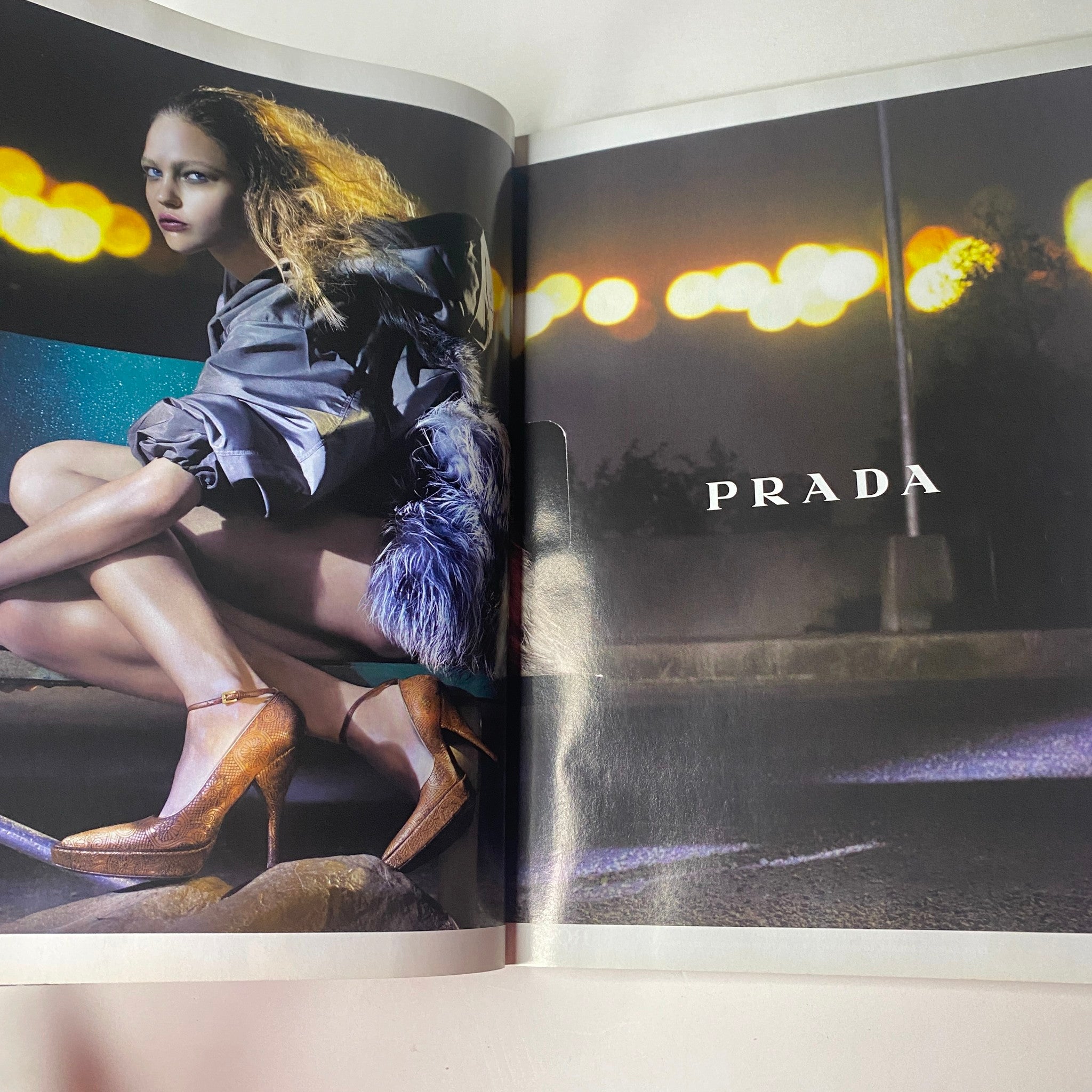 Prada advertisement spread from Vogue British Magazine August 2006, featuring a model in a high fashion setting with striking footwear.