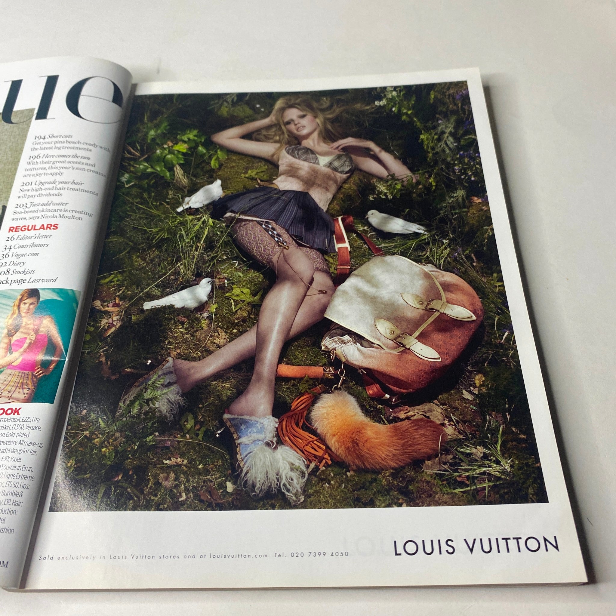 Vogue British Magazine June 2010 Angela Lindvall Cover No Label VG featuring a high-fashion Louis Vuitton advertisement, showcasing a model lying amidst nature surrounded by small birds.