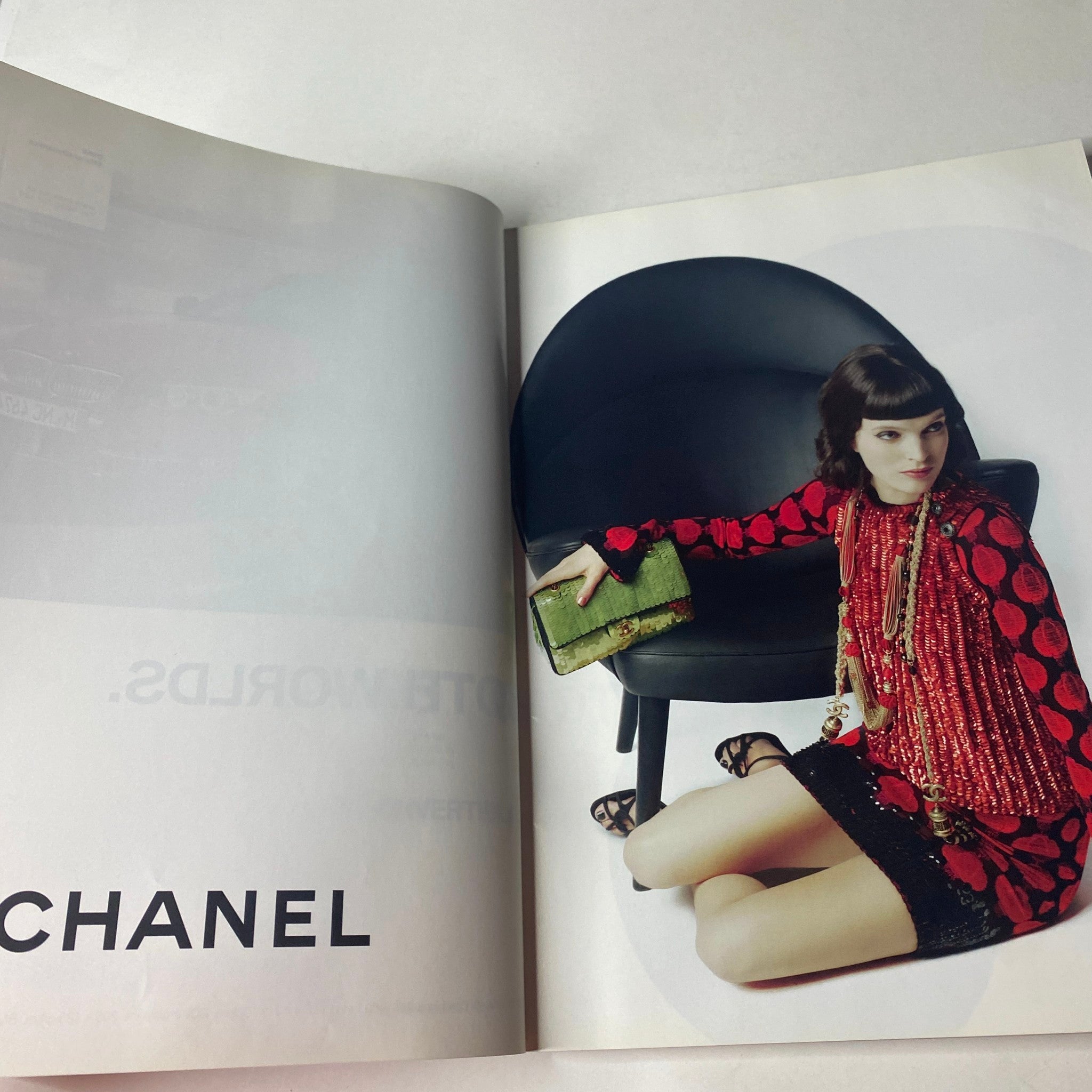 Chanel advertisement page from Vogue British Magazine July 2010 featuring a stylish model in a red polka dot dress holding a green clutch.