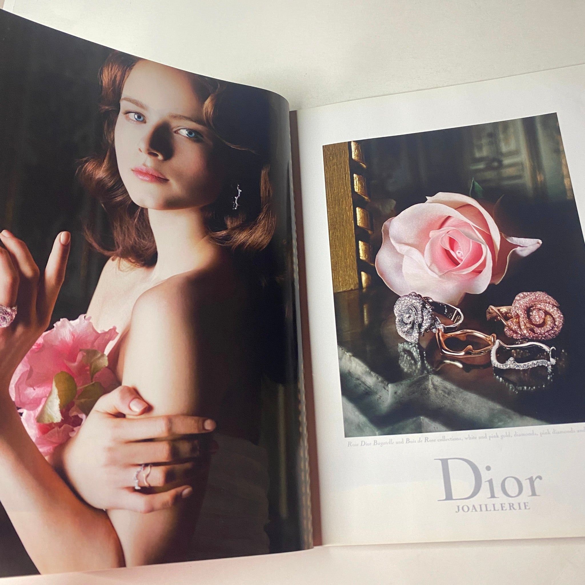 Dior jewelry advertisement from Vogue British Magazine July 2010, displaying a model adorned with elegant rings and earrings alongside a rose.