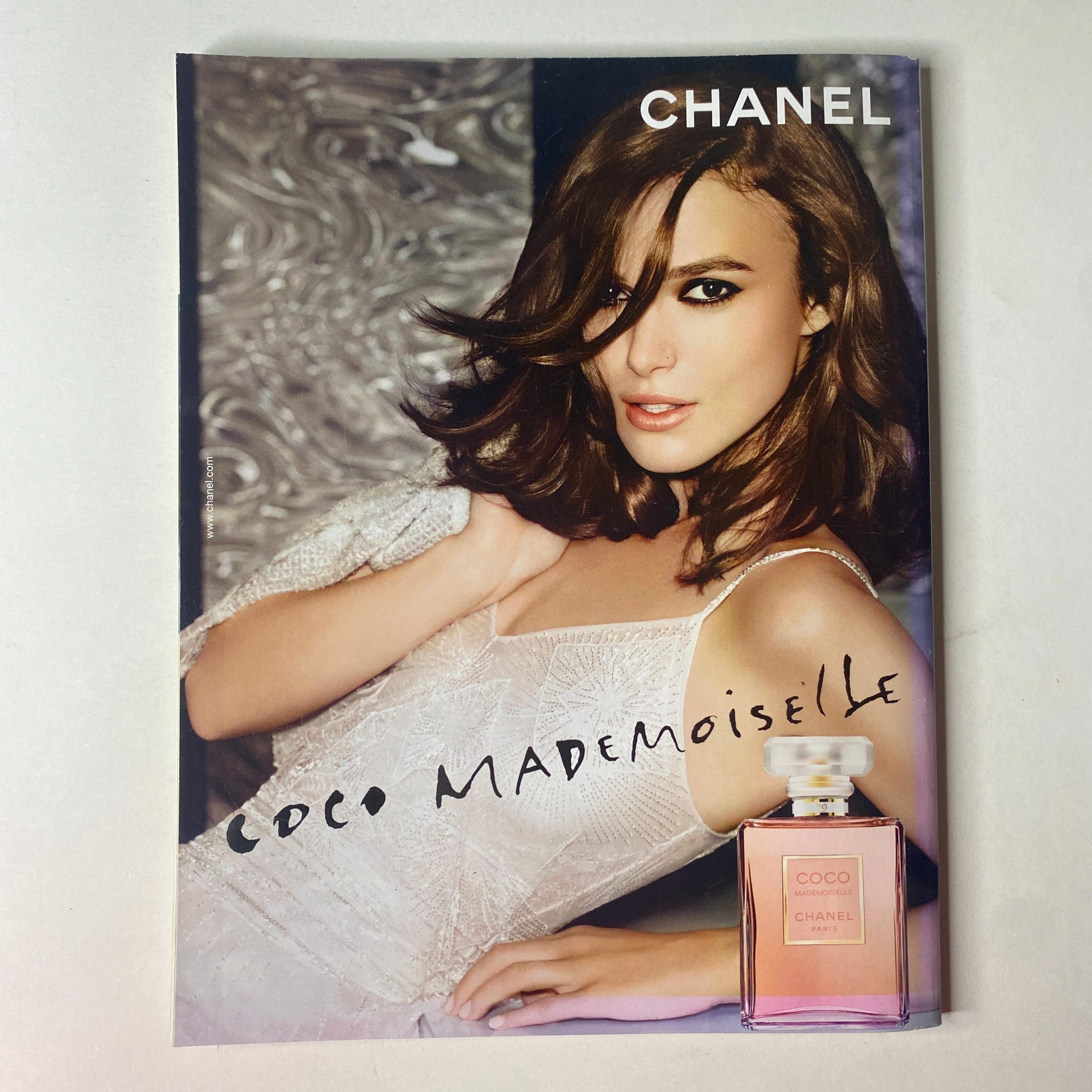 Vogue British Magazine February 2015 presenting a captivating advertisement for Chanel Coco Mademoiselle featuring a model with luxurious hair and elegant attire.