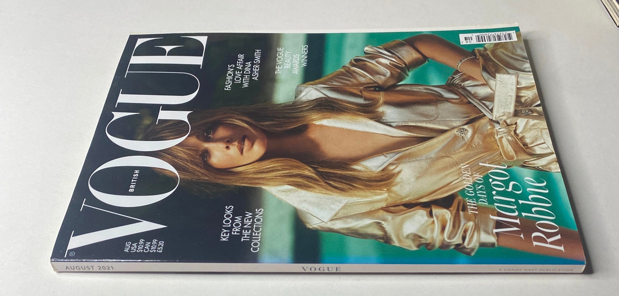 Back cover of Vogue British Magazine August 2021 highlighting key looks from new collections and featuring Margot Robbie, underscoring her influence in the fashion industry.