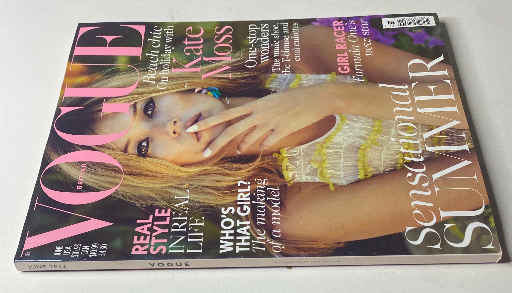 Side view of the Vogue British Magazine June 2013 with Kate Moss on the cover, emphasizing its good condition and summer fashion themes as it lays on a white background.
