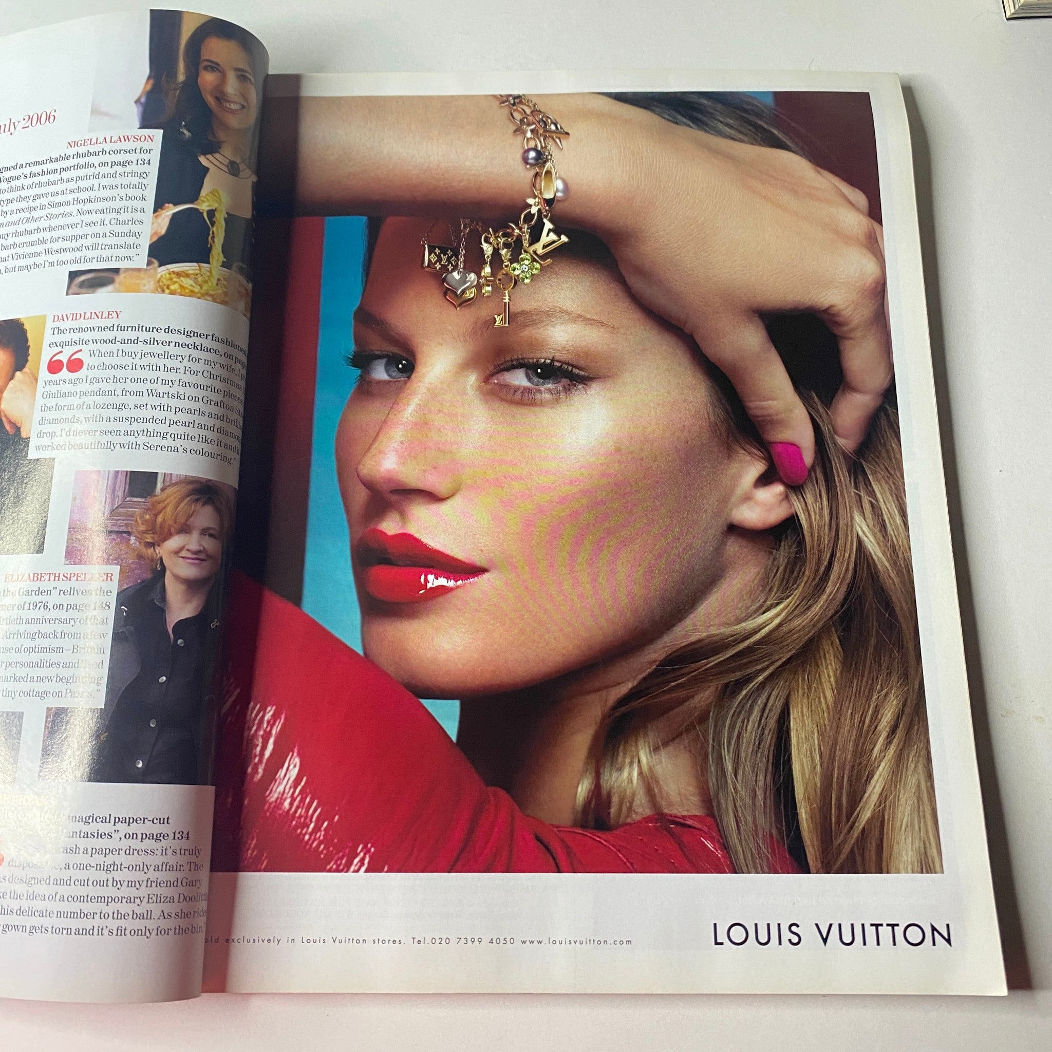 Vogue British Magazine July 2006 showcasing a striking beauty editorial with a model featuring bold red lipstick and elegant accessories from Louis Vuitton.