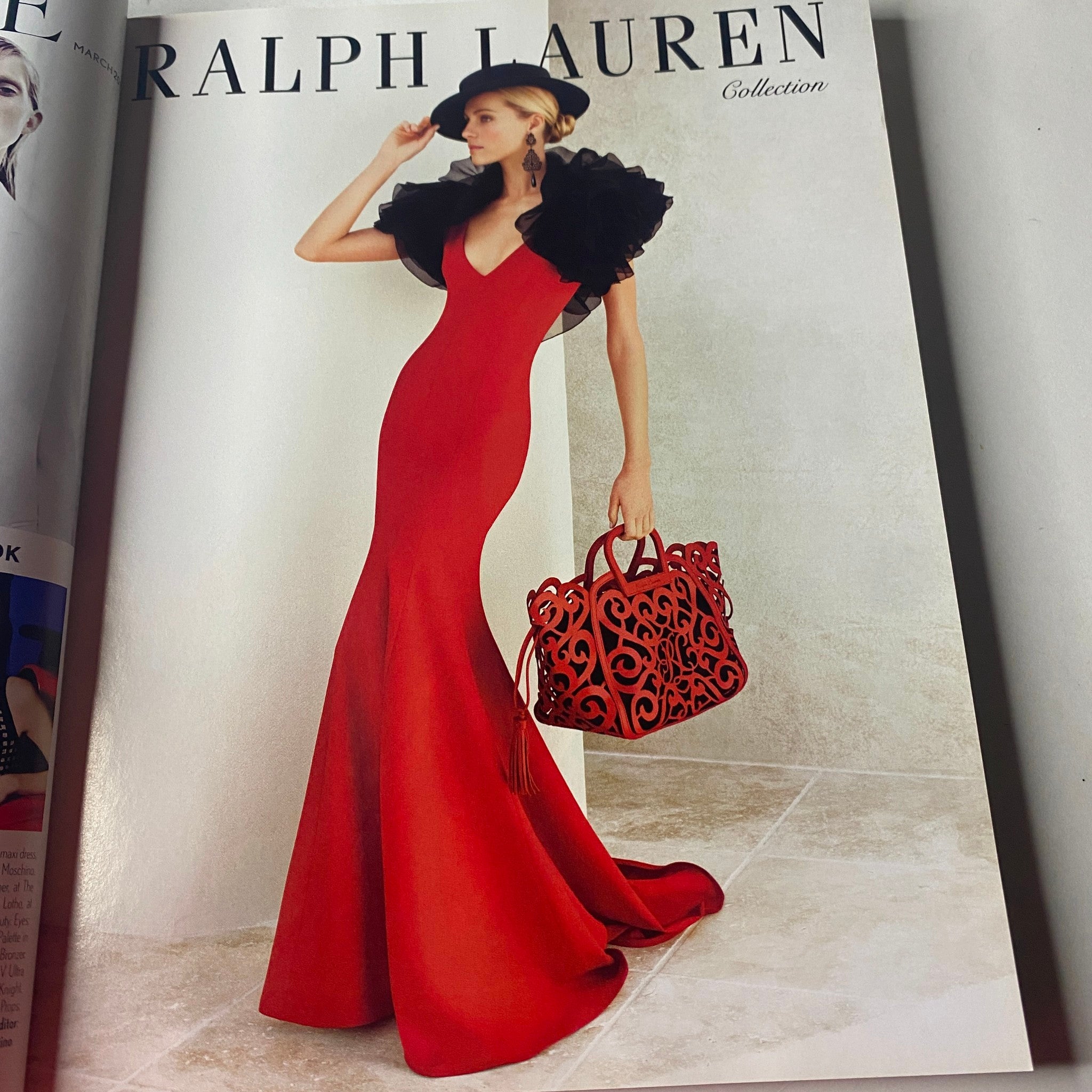 Advertisement in Vogue British Magazine March 2013 featuring a stunning red Ralph Lauren gown with dramatic ruffles and a stylish handbag.