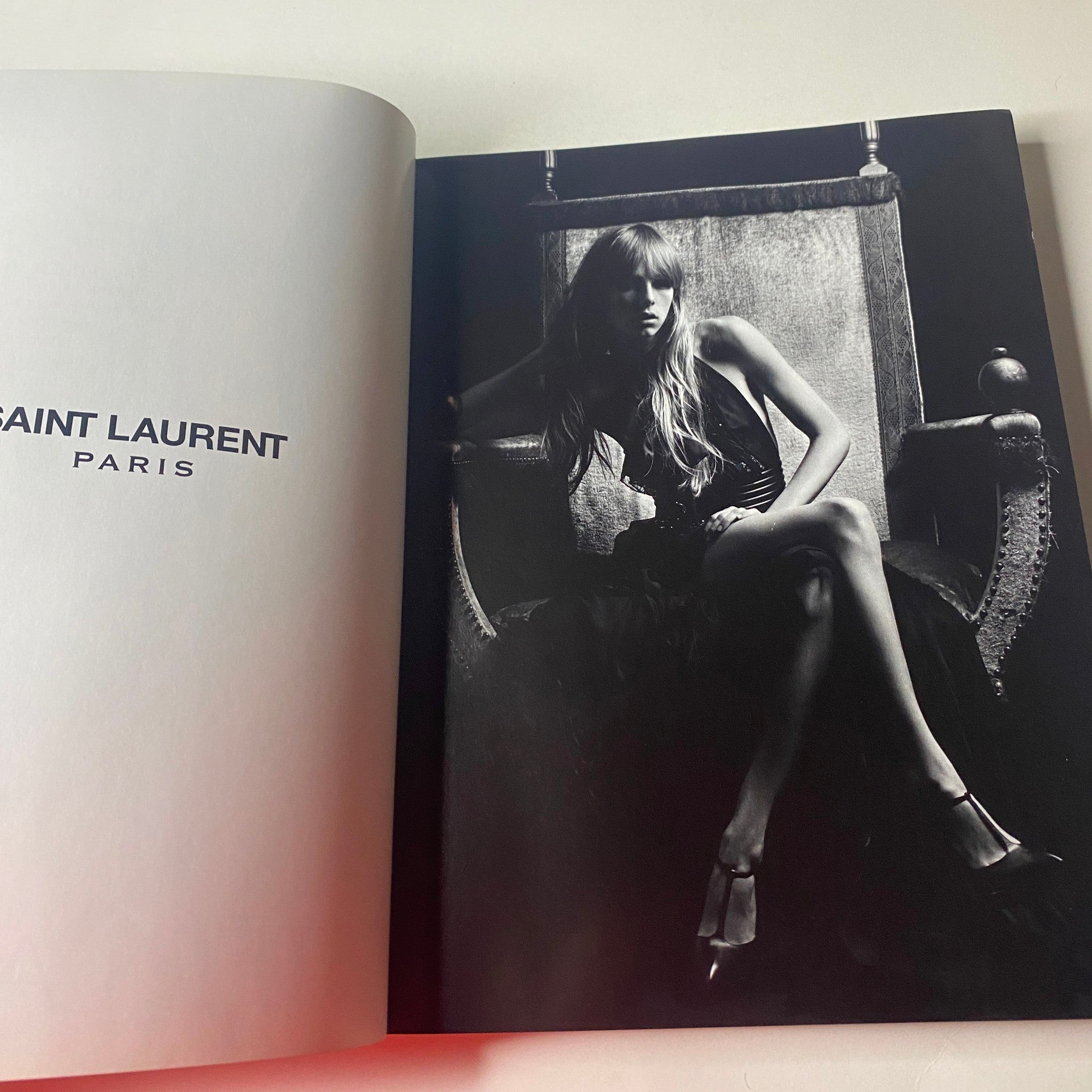 Black and white editorial in Vogue British Magazine March 2013 featuring a high-fashion model in dramatic pose, showcasing Saint Laurent pieces.