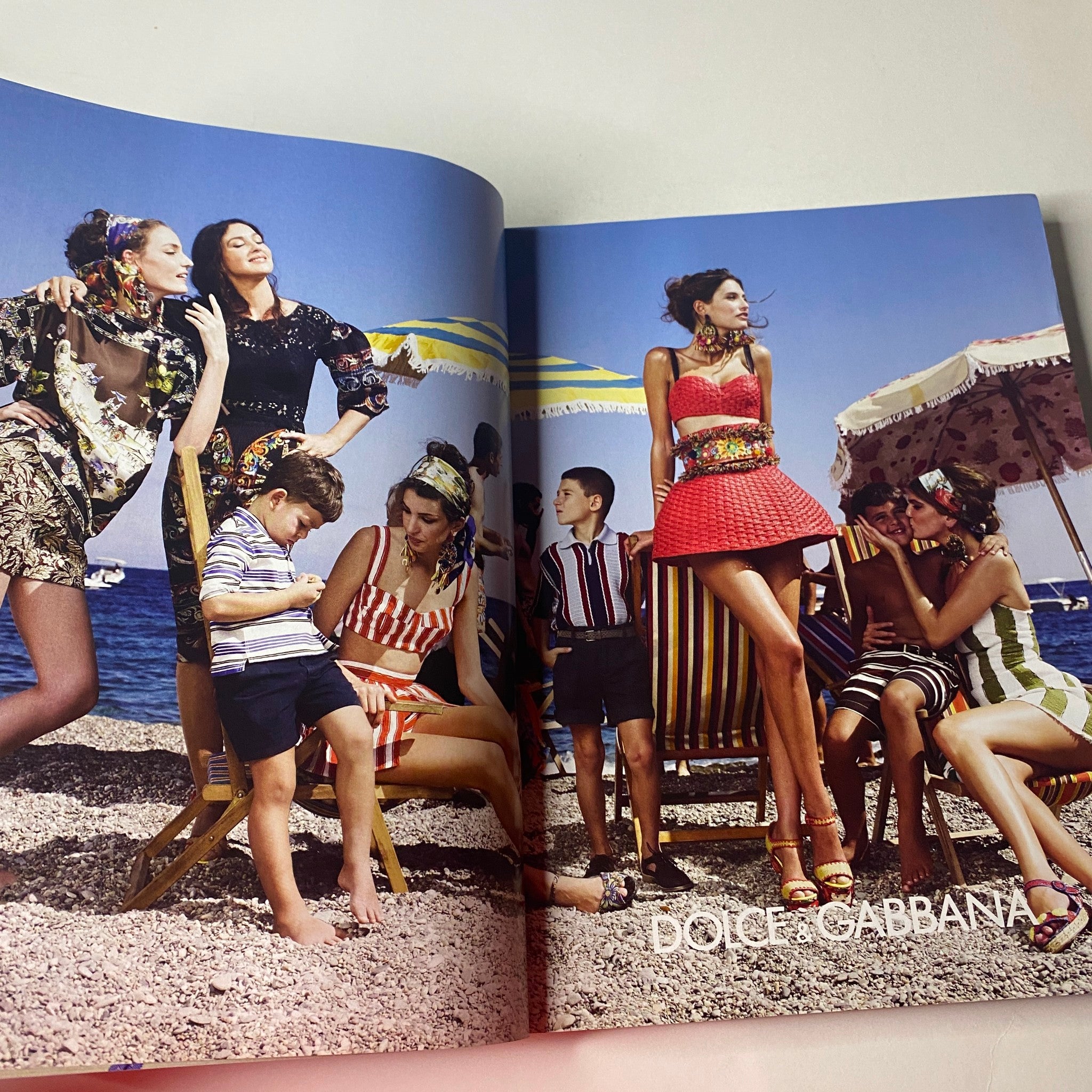 Vogue British Magazine March 2013 Cara Delevingne Cover showcasing a Dolce & Gabbana editorial with stylish beachwear designs and a family on the beach.