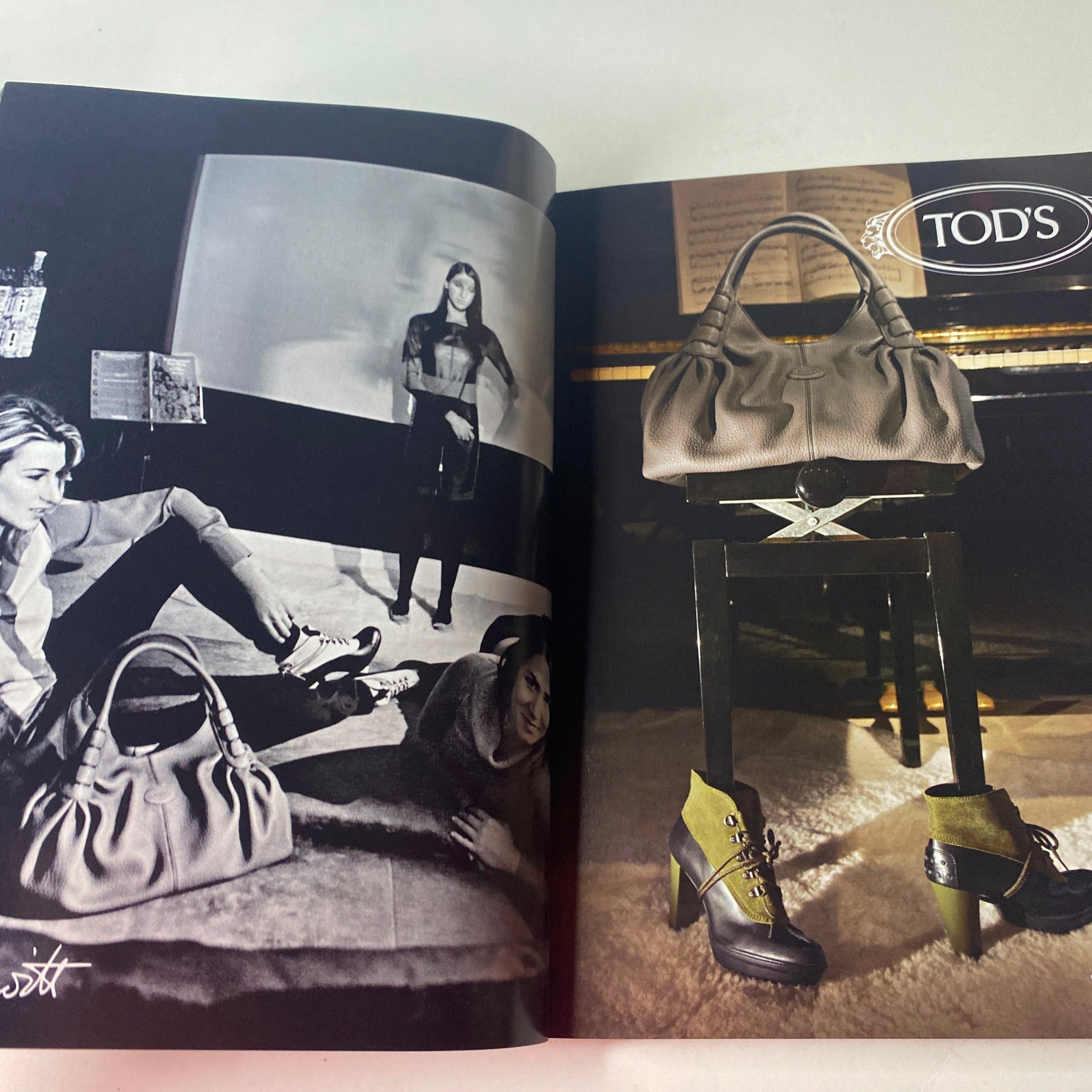 An advertisement spread from Vogue British Magazine October 2010 featuring a Tod's handbag and shoes. The sophisticated layout showcases luxury fashion items within a stylish black and white aesthetic.