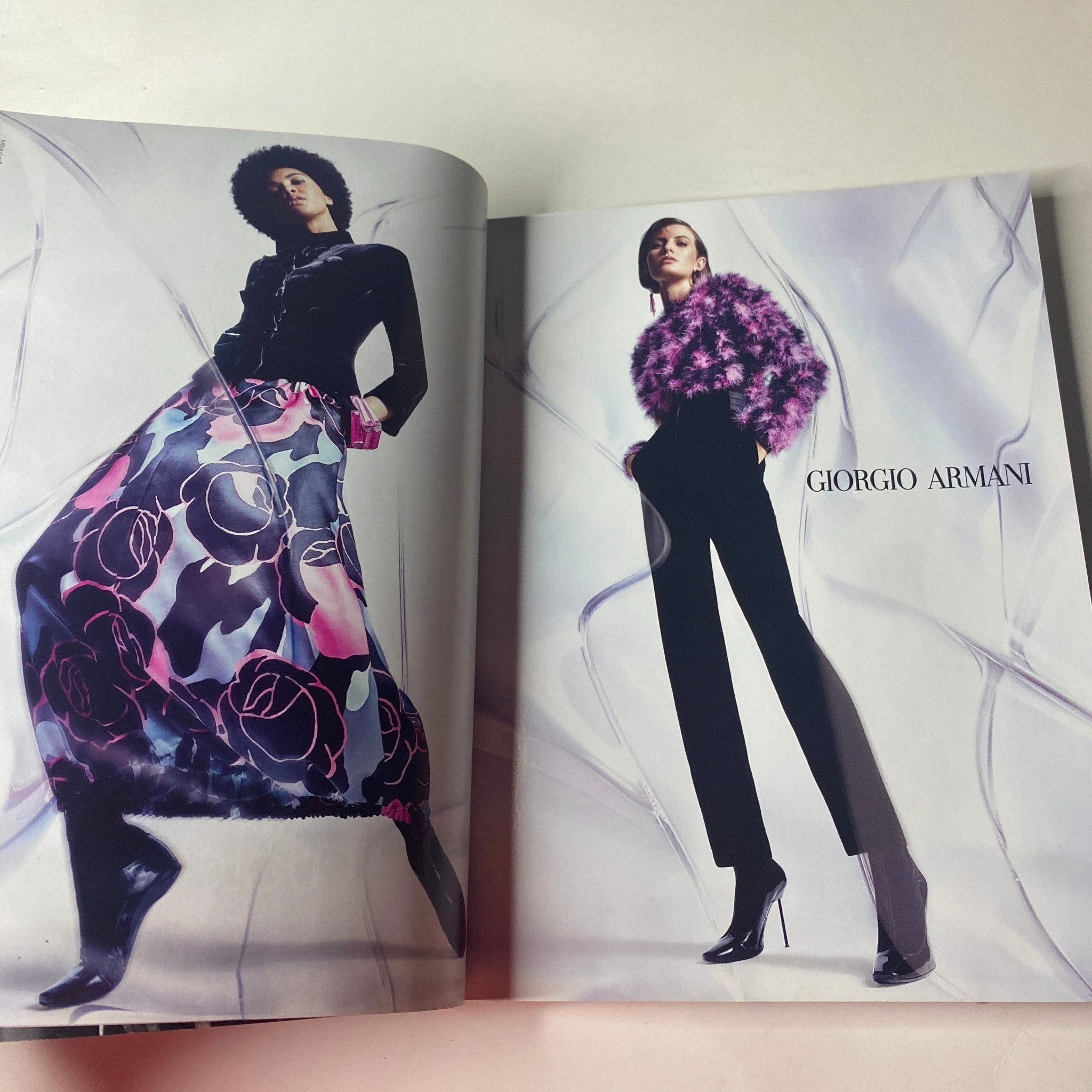 Giorgio Armani fashion presented in Vogue British Magazine September 2020 with models wearing elegant and chic outfits against a sleek background.