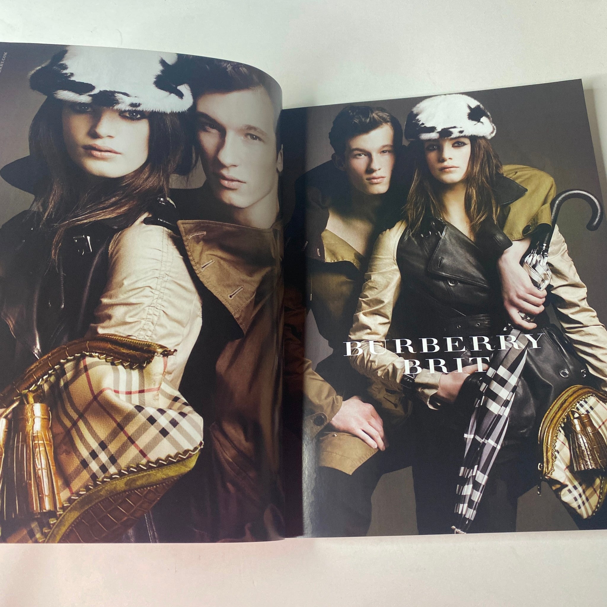 Vogue British Magazine August 2011 featuring a fashion editorial spread with models styled in Burberry attire, showcasing chic coats and accessories.