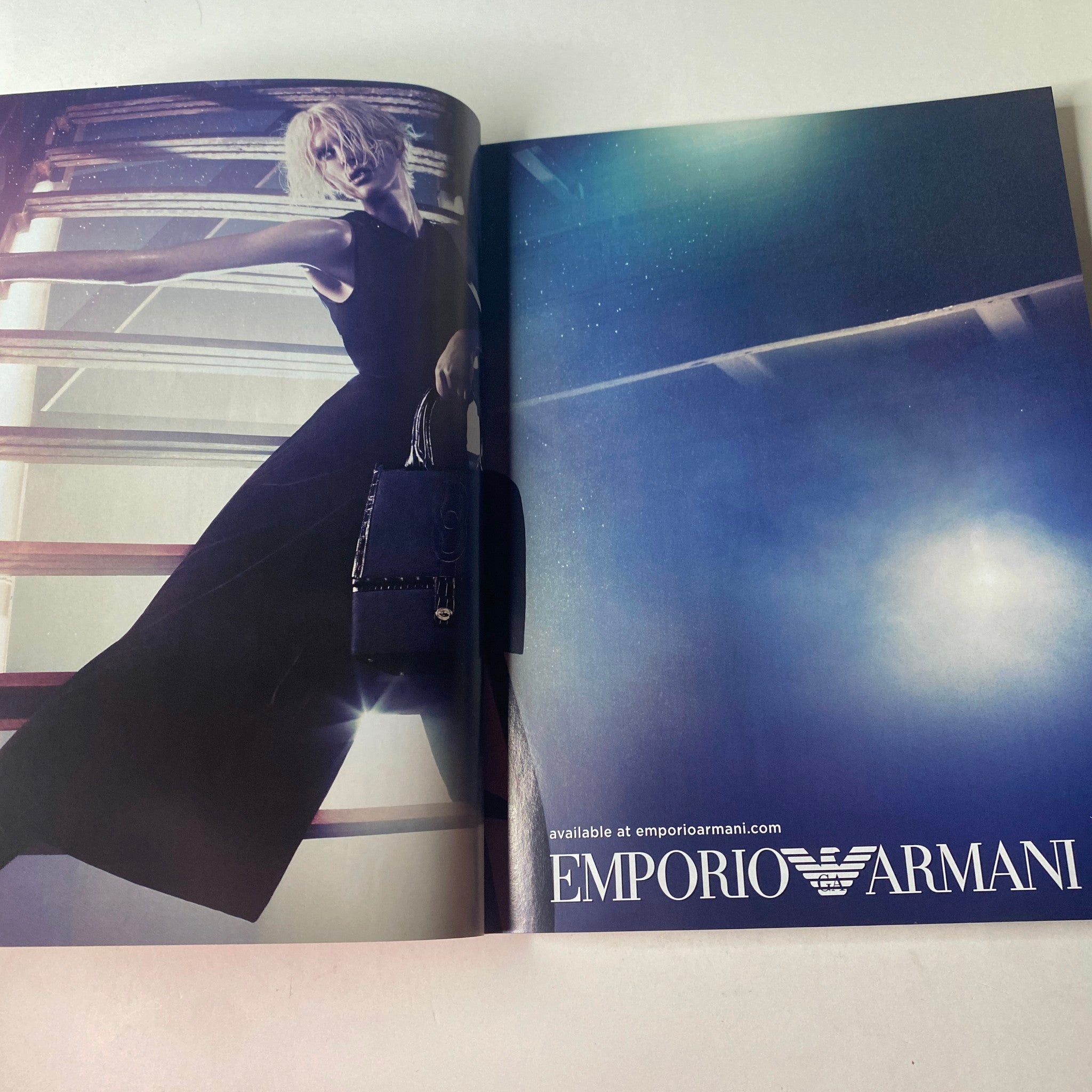 Vogue British Magazine August 2011 highlighting a glamorous ad for Emporio Armani, featuring a model in an elegant dress against a dramatic backdrop.