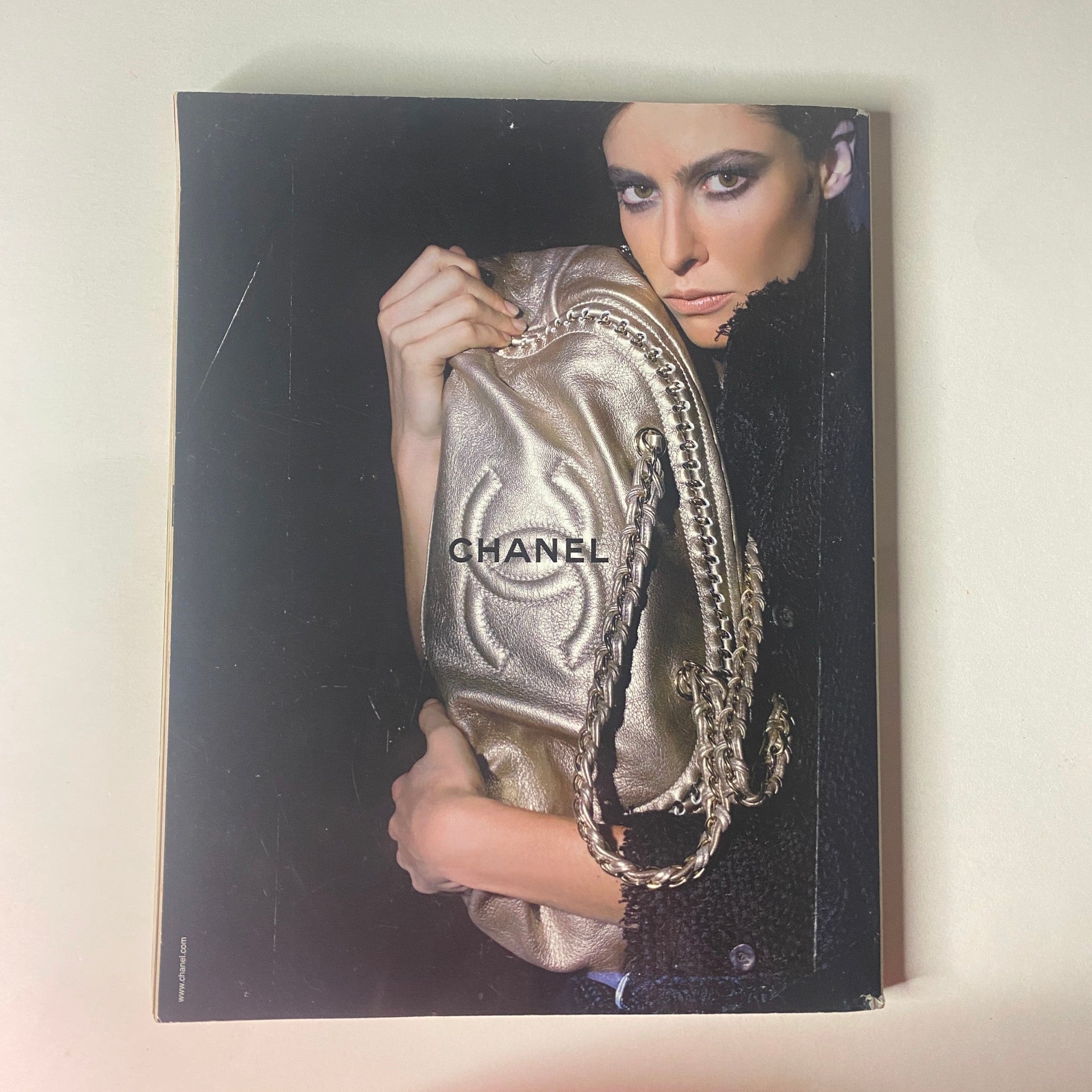 Cover of a Chanel promotional piece, illustrating a model with a metallic handbag, associated with Vogue British Magazine April 2006 featuring Rachel Weisz on the cover.