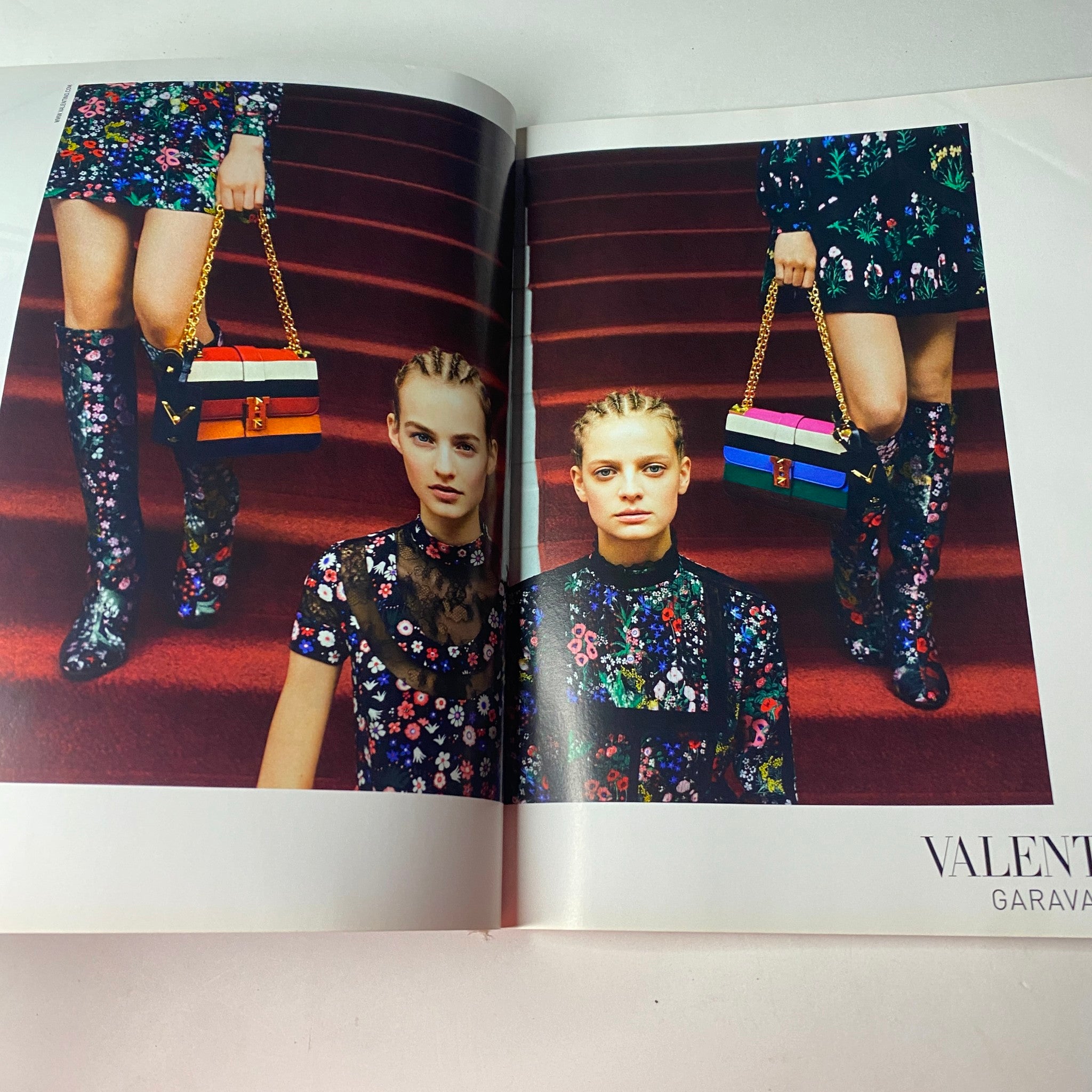 Fashion editorial spread from Vogue British Magazine July 2015 featuring models in vibrant floral outfits by Valentino, celebrating eclectic summer fashion trends.