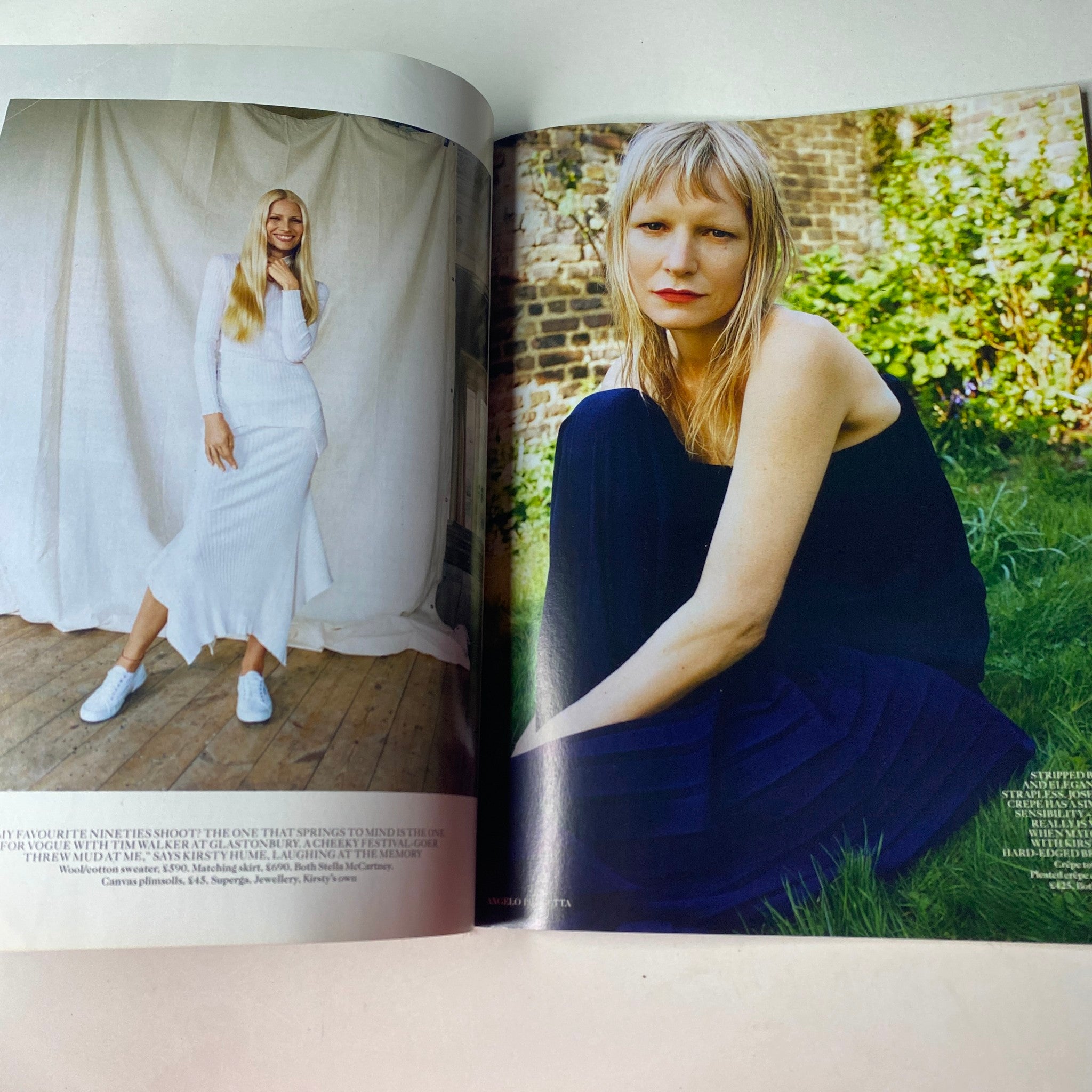 Vogue British Magazine July 2015 Stella Tennant Cover No Label VG, featuring a spread with two fashion models, one in a white dress and the other in a dark outfit, showcasing contemporary styling in a beautiful outdoor setting.