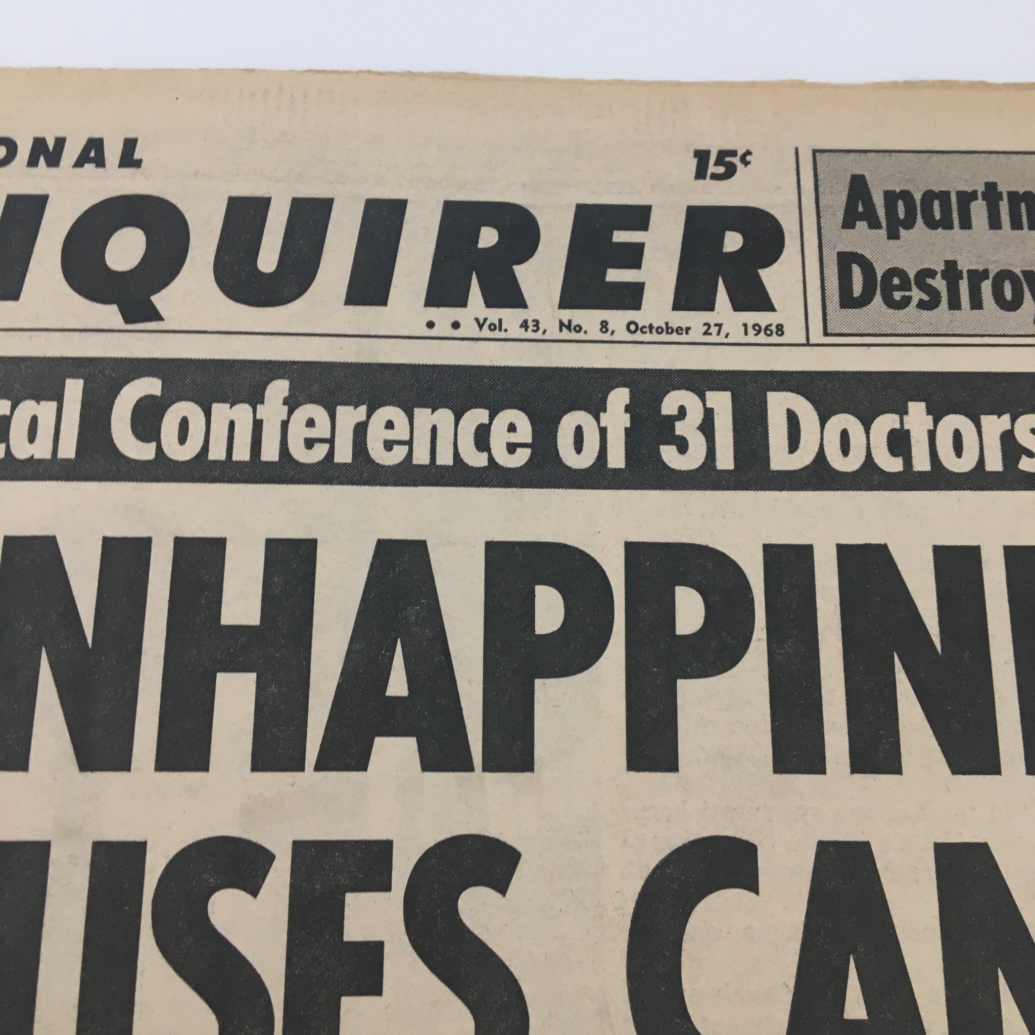 Close-up of the National Enquirer newspaper title from October 27, 1968, highlighting a report on unhappiness causing cancer and its associated medical insights.