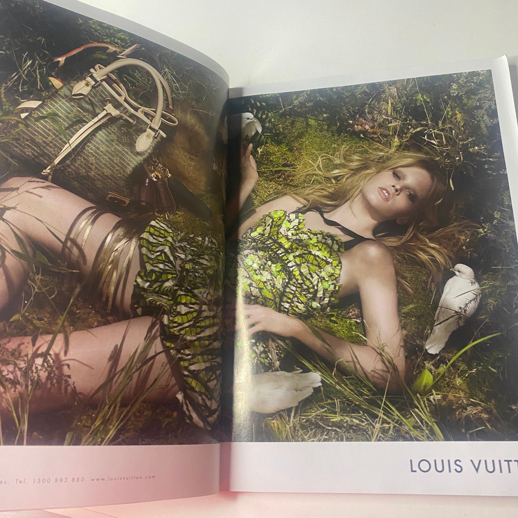 Vogue Australia Magazine April 2010 featuring a high-fashion editorial spread with a model in a vibrant floral dress, surrounded by nature, showcasing a luxury bag. Ideal for collectors and fashion enthusiasts.