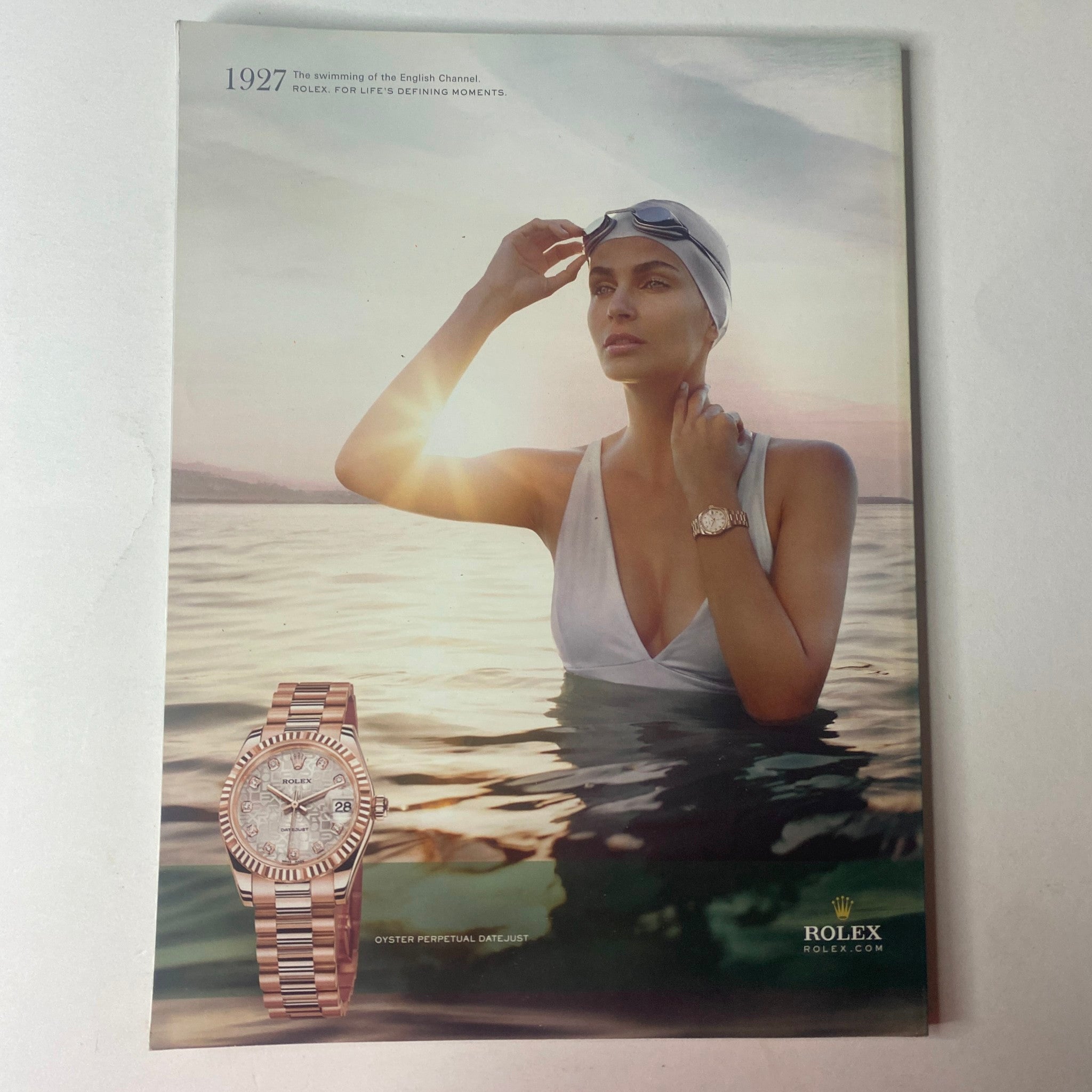 Vogue Australia Magazine January 2010 Catherine McNeil Cover, featuring an exquisite Rolex watch advertisement, showcasing a model in a stylish swimsuit by the water, embodying sophistication and luxury.