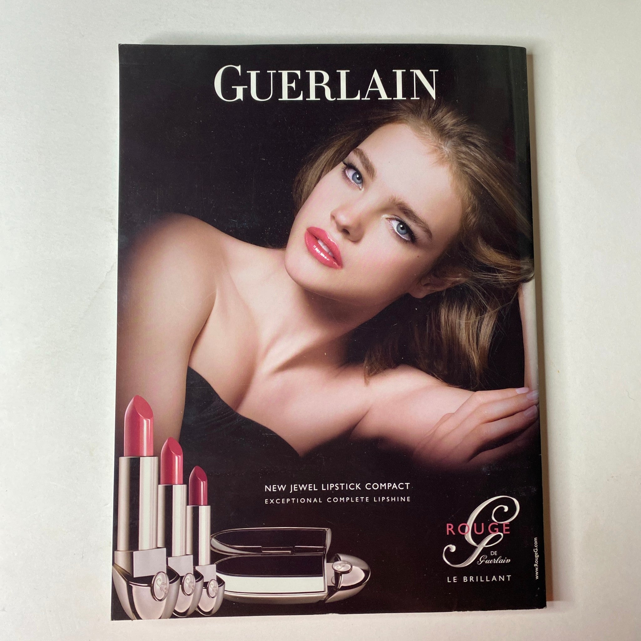 Advertisement for Guerlain cosmetics featured in 'Vogue Australia Magazine June 2010', showcasing their new jewel lipstick compact with vibrant lipstick shades for beauty enthusiasts.