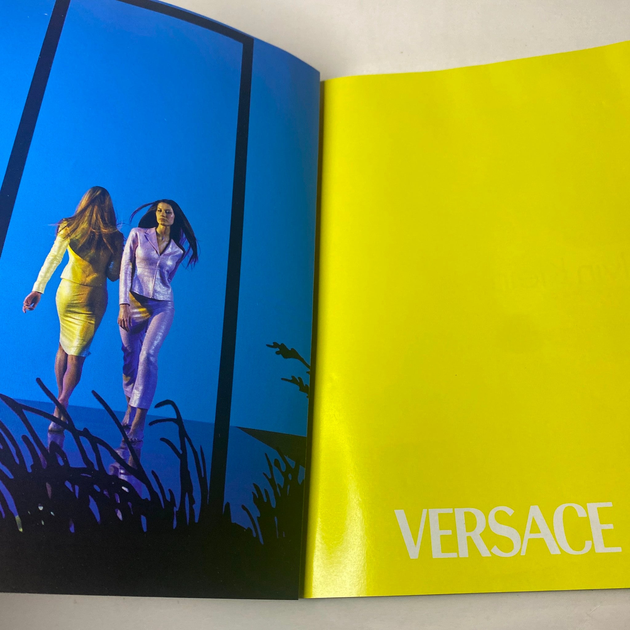 Fashion advertisement in Harper's Bazaar Magazine February 1999, featuring a Versace spread with models showcasing vibrant colors and modern styles.