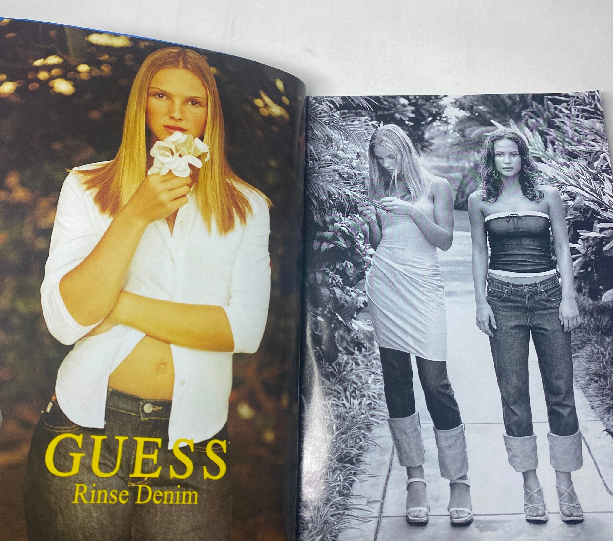 Guess denim advertisement featured in Harper's Bazaar Magazine February 1999, highlighting fashion trends with a focus on jeans and casual styles.