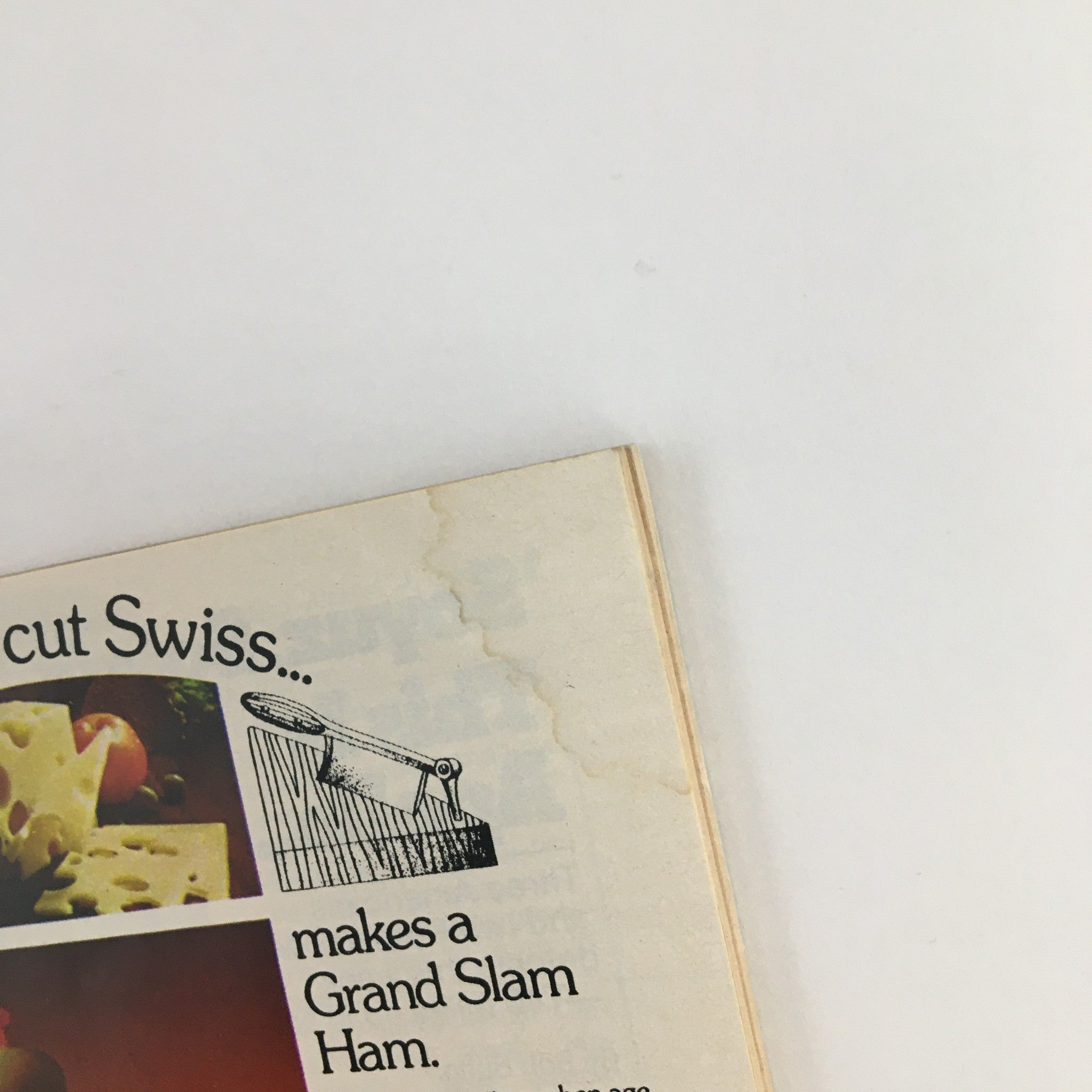 Detail of the corner of TV Guide Magazine July 12 1975, highlighting an advertisement for Swiss cheese and a vintage illustration, reflecting 1970s design elements.