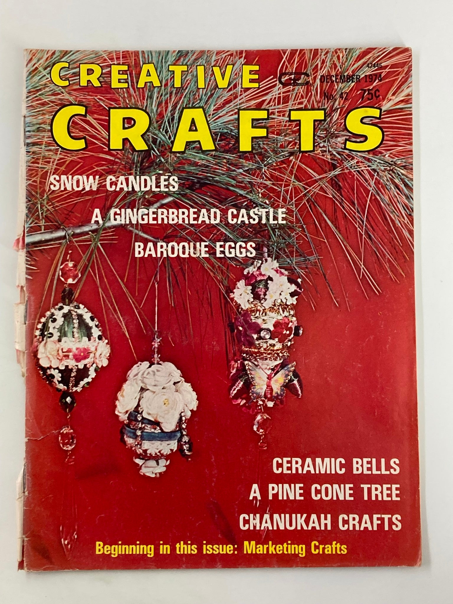 Cover of VTG Creative Crafts Magazine December 1974 featuring ceramic bells, a pine cone tree, and a colorful snowy background. The magazine showcases vintage crafting ideas.