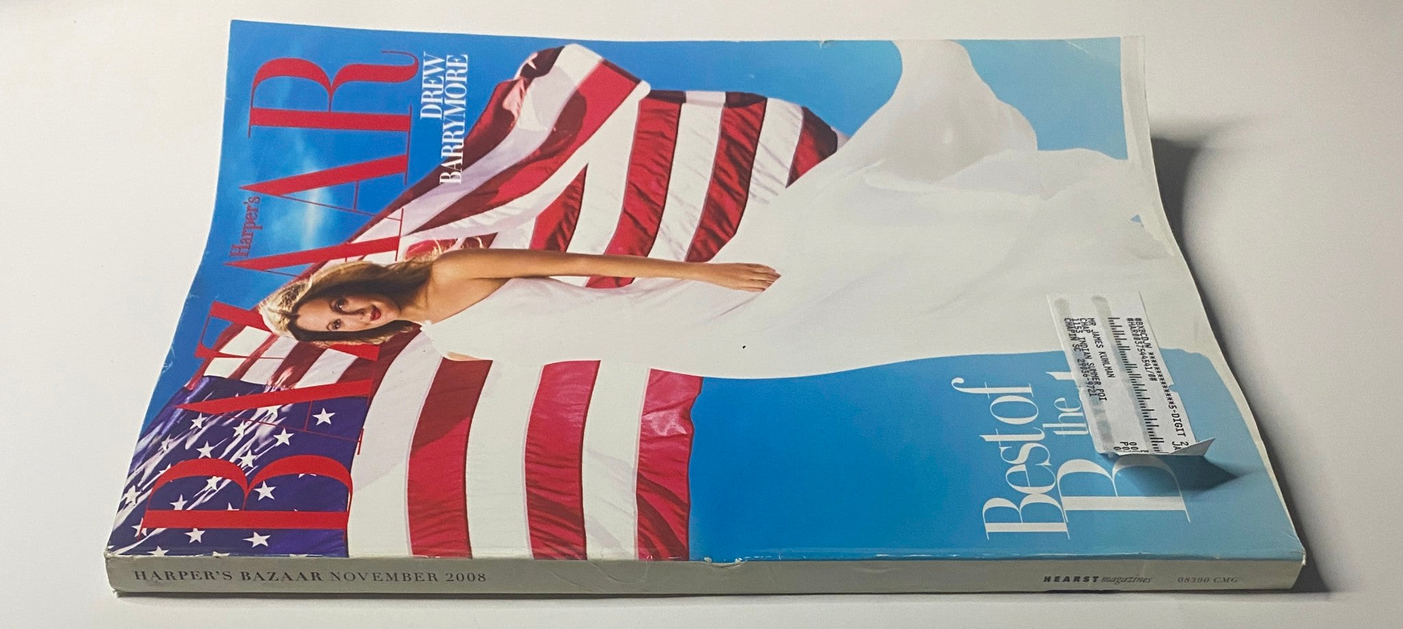 Harper's Bazaar Magazine November 2008 featuring Drew Barrymore on the cover, dressed in elegant clothing against a backdrop of the American flag. Very good condition, showcasing the blend of fashion and patriotism.