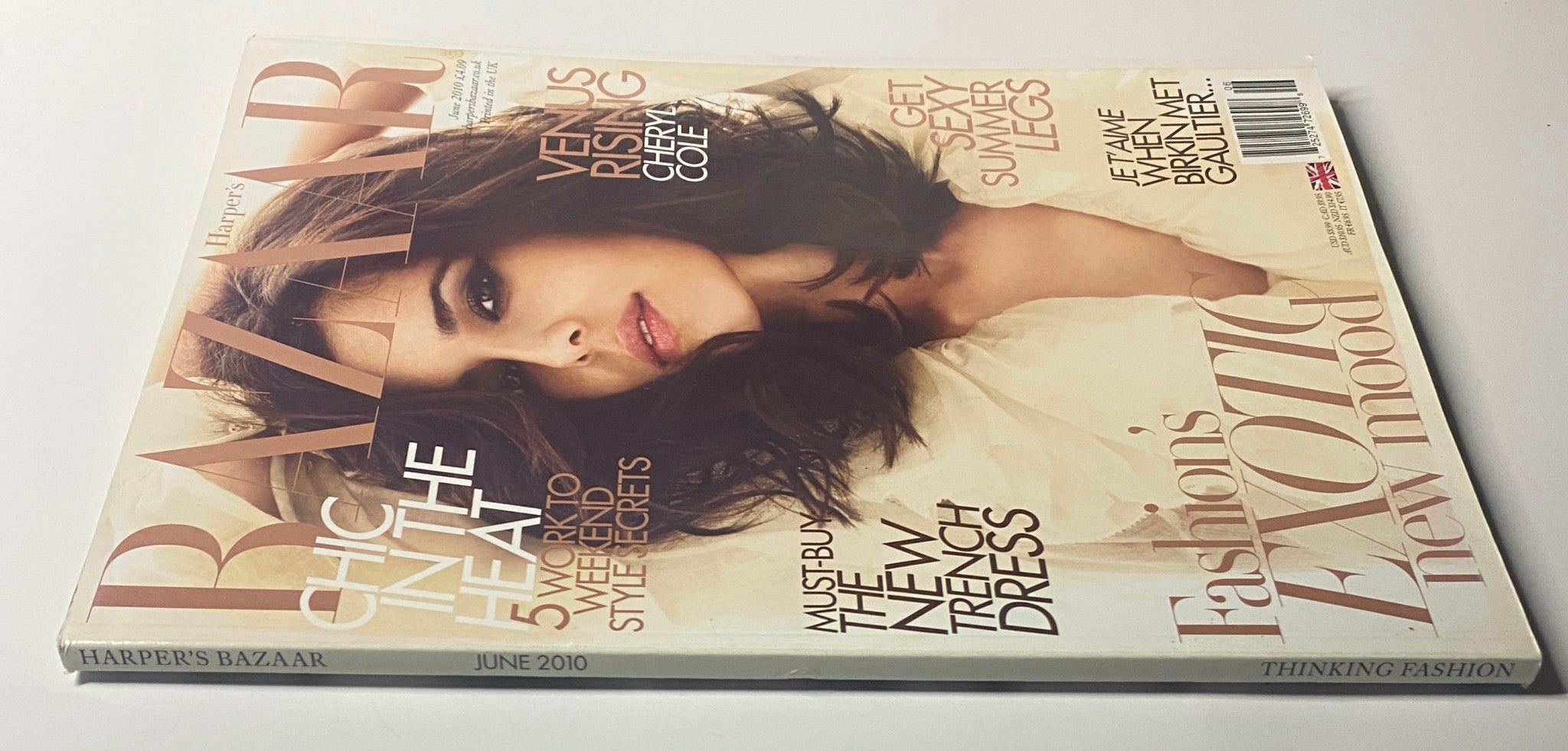 Another view of the June 2010 Harper's Bazaar Magazine cover, showcasing Cheryl Cole. The cover emphasizes fashion trends with 'Must-Buy: The New Trench Dress' and 'Fashion's Exotic New Mood'.