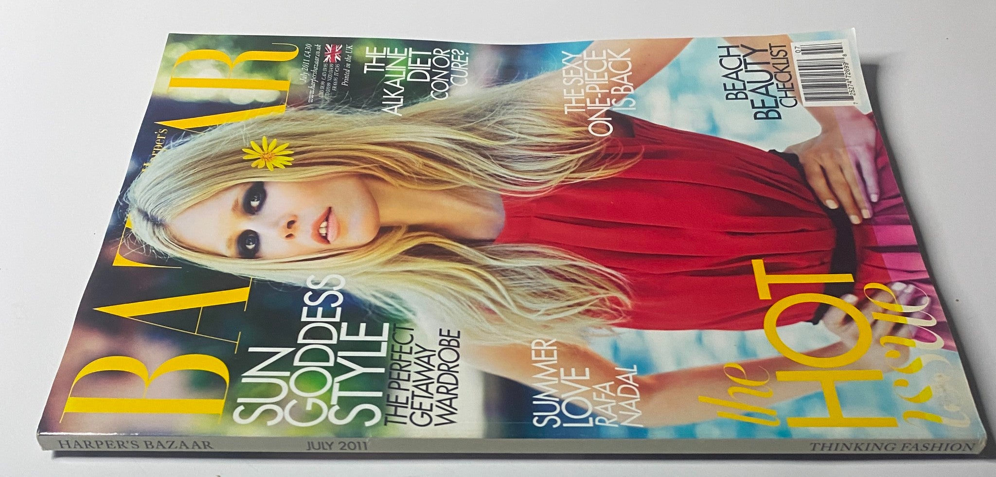 Side view of Harper's Bazaar UK Magazine July 2011 showcasing Claudia Schiffer on the cover, highlighting sun goddess style and summer fashion.