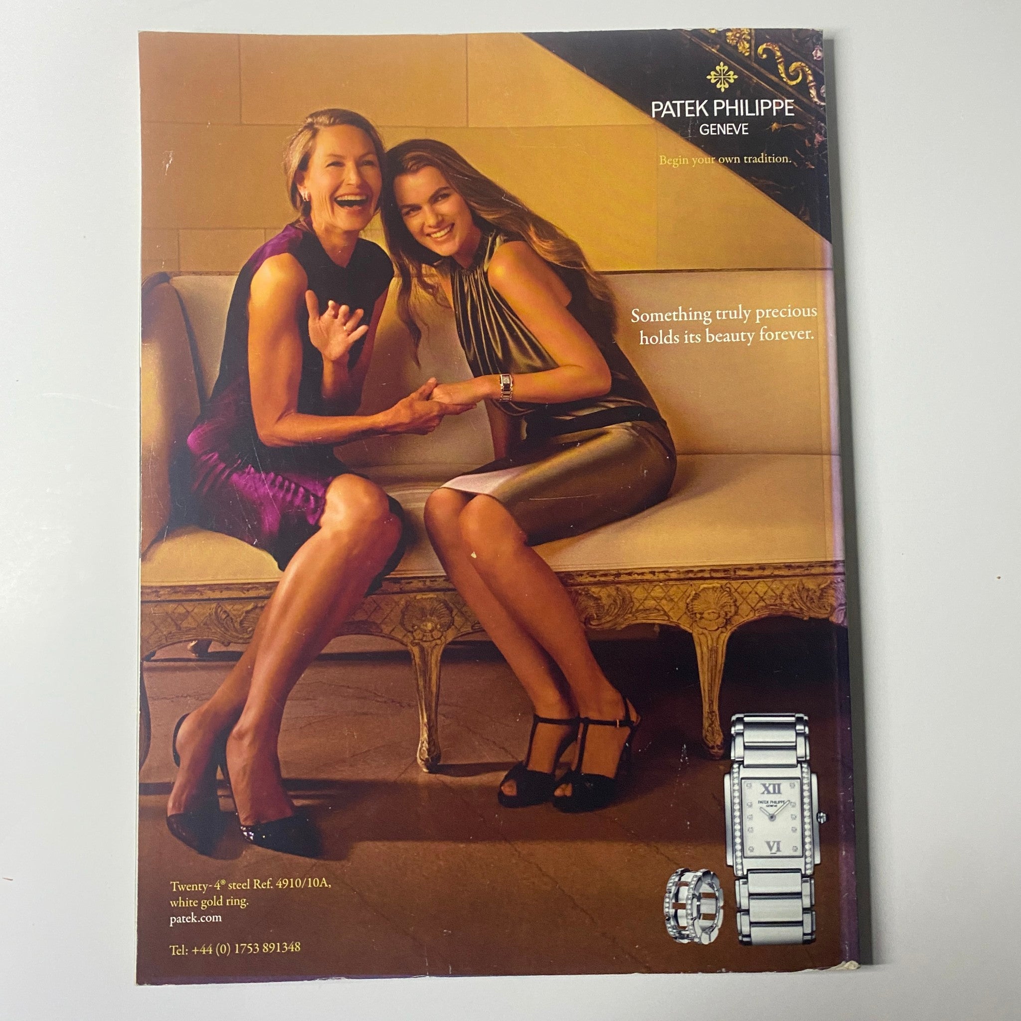 Advertisement from Harper's Bazaar UK Magazine July 2011 for Patek Philippe featuring two women enjoying a moment together, highlighting luxury watches.