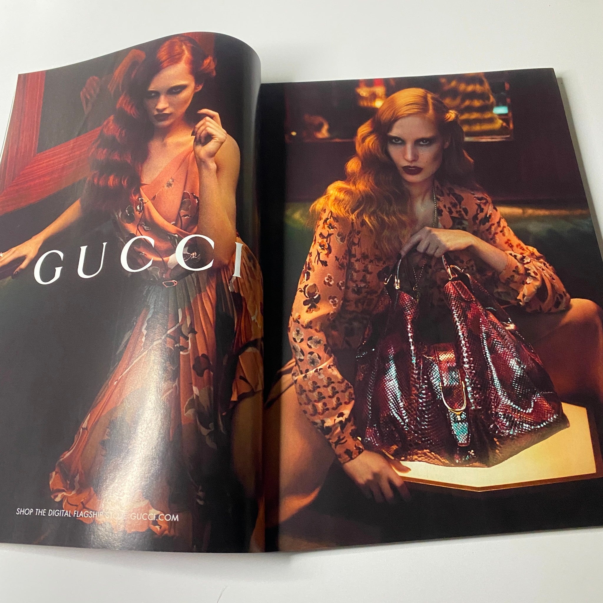 Gucci advertisement featuring a striking model in a chic outfit and stylish handbag, presented in Harper's Bazaar UK Magazine July 2012.