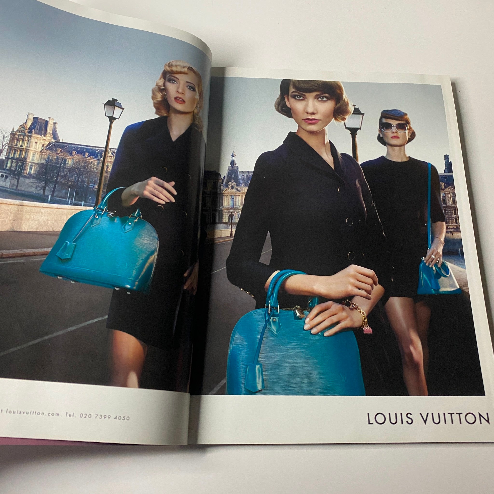 Inside Harper's Bazaar UK Magazine May 2013 featuring a Louis Vuitton advertisement with models showcasing stylish black outfits and turquoise handbags, highlighting fashion in a Parisian setting.