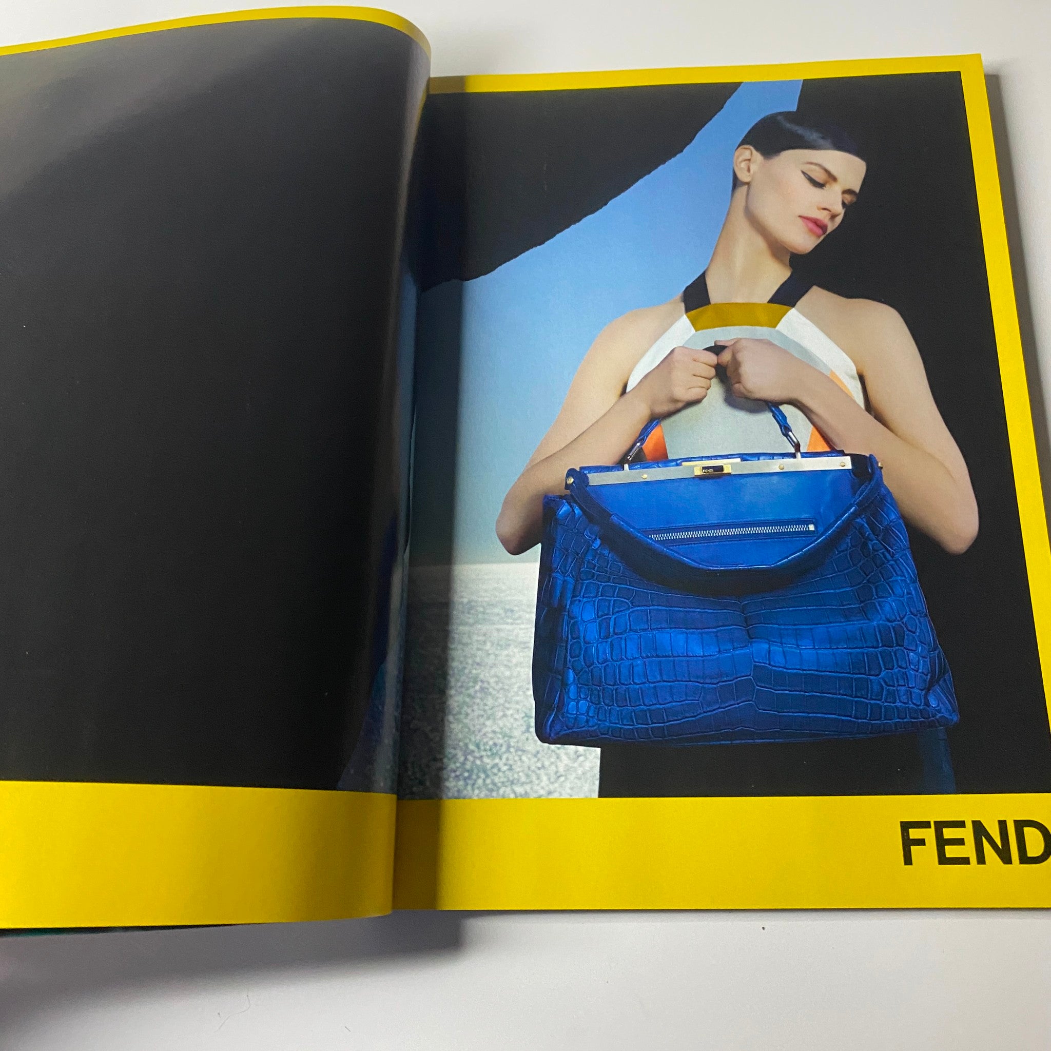 Fendi advertisement featuring a model showcasing a stylish blue handbag, highlighted in the April 2013 issue of Harper's Bazaar UK with Kate Winslet on the cover.