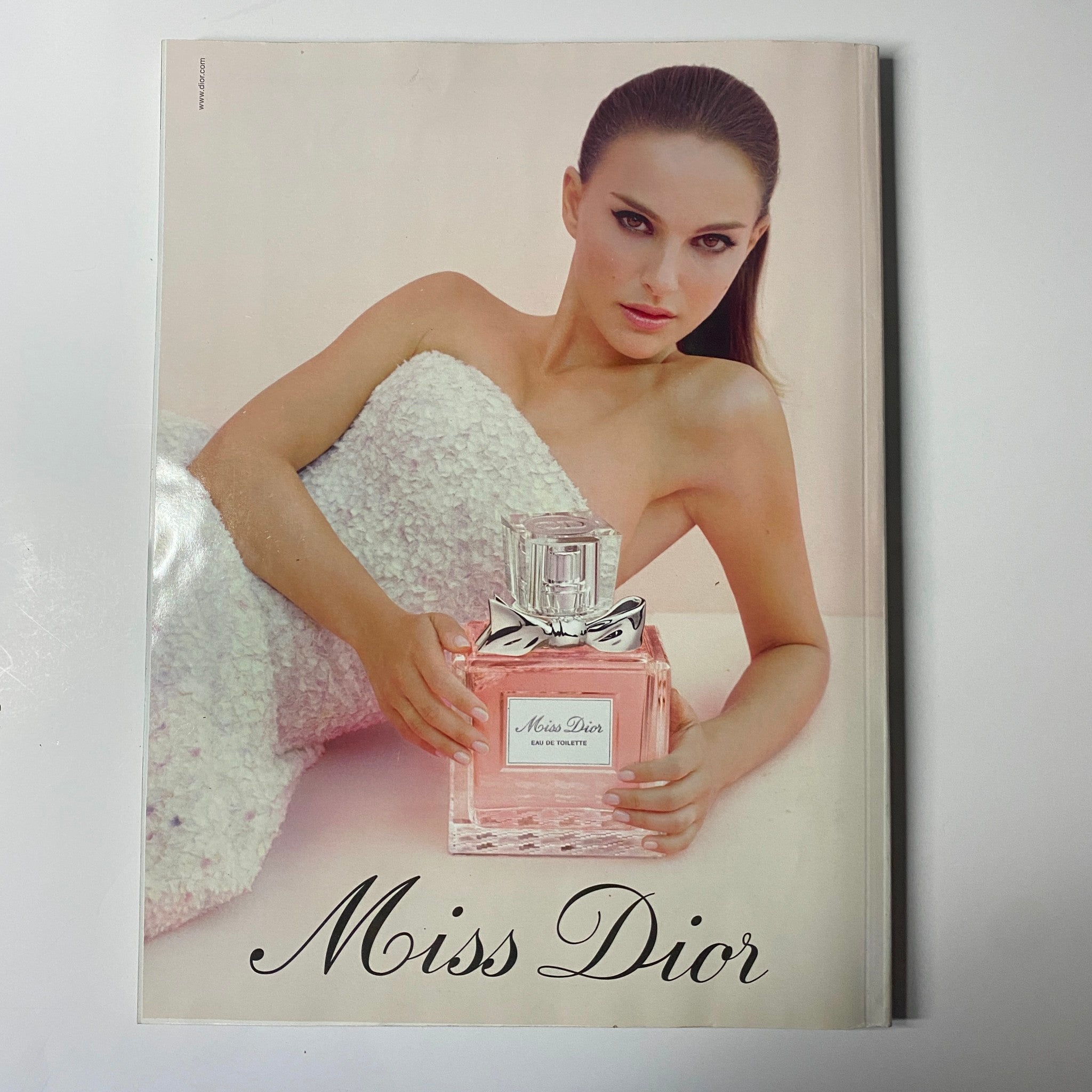 Miss Dior perfume advertisement showing a glamorous model holding the fragrance, from the April 2013 edition of Harper's Bazaar UK featuring Kate Winslet.
