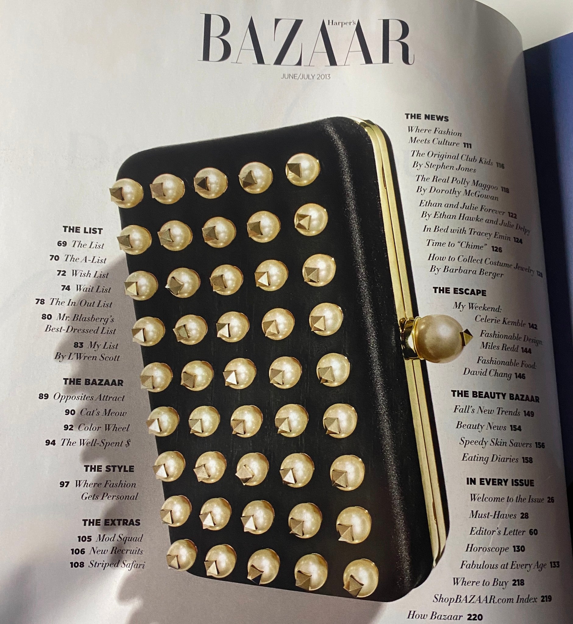 Another interior page of Harper's Bazaar Magazine June - July 2013 displaying a stylish black clutch, highlighting fashion and accessory trends.