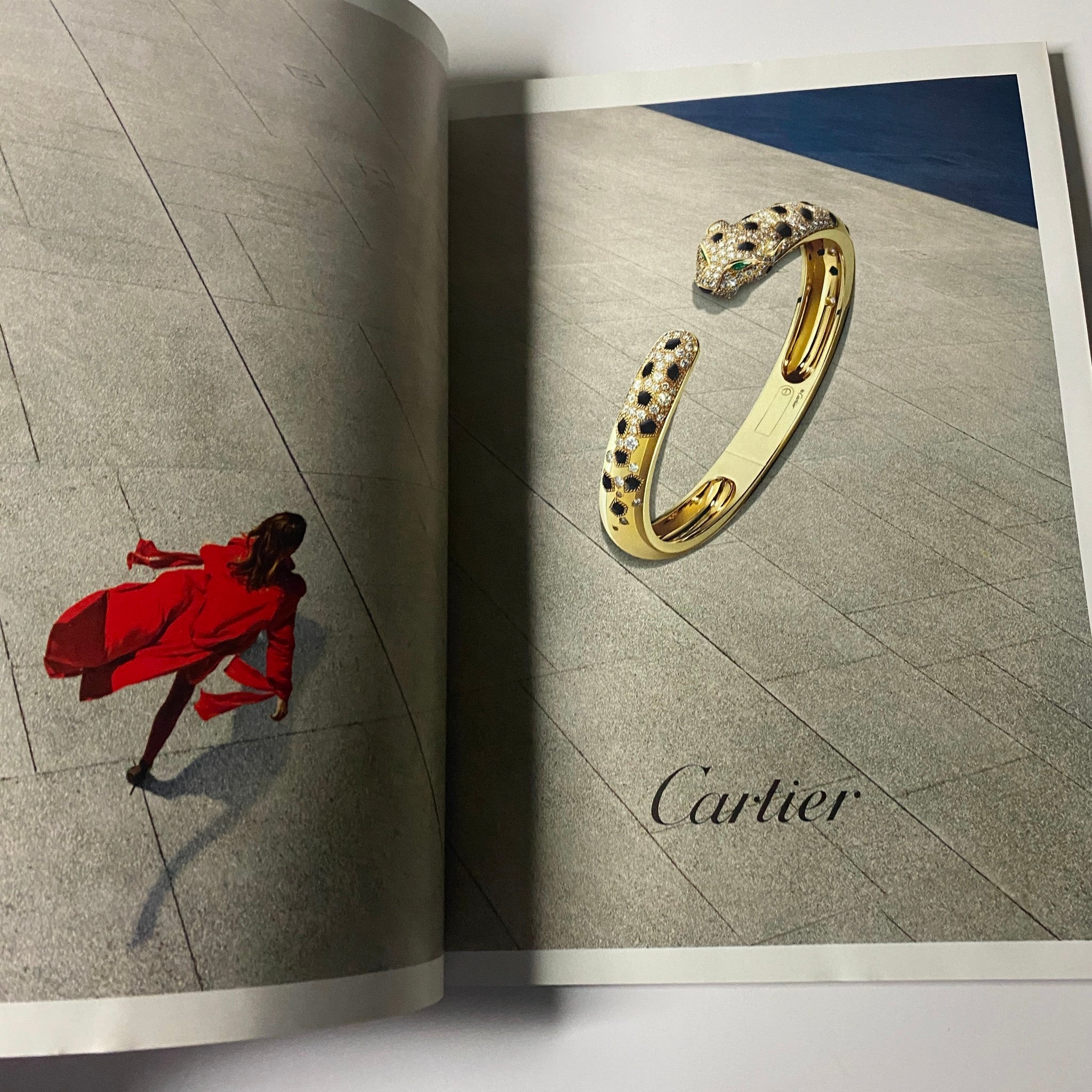 Harper's Bazaar UK Magazine July 2020 displaying a luxurious Cartier advertisement showcasing an exquisite gold serpent bracelet in an artistic setting.