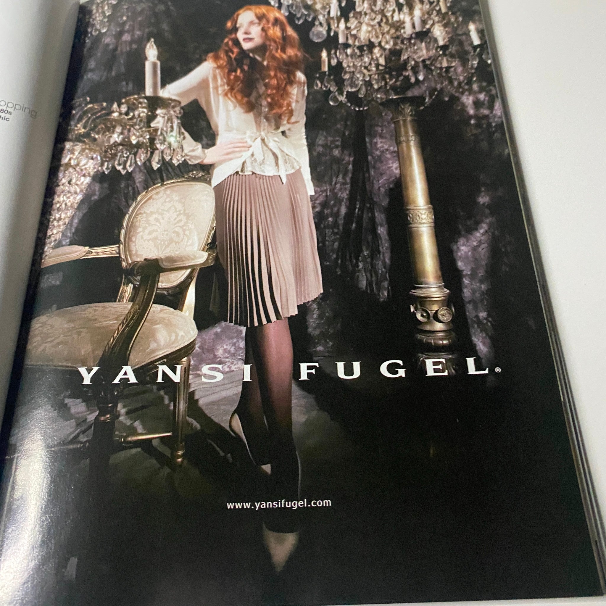 Fashion advertisement for Yansi Fugel featured in Harper's Bazaar Magazine August 2006, showcasing elegant clothing and accessories amidst a luxurious backdrop.