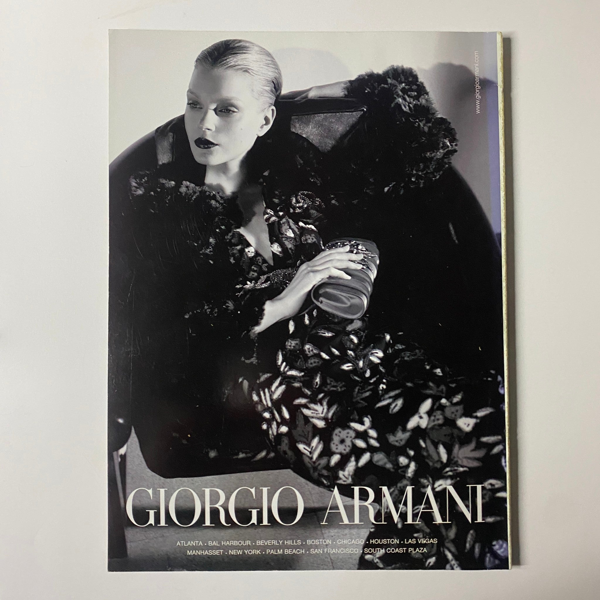 Giorgio Armani fashion advertisement in Harper's Bazaar Magazine August 2006, featuring a high-fashion model in a striking black and floral ensemble.