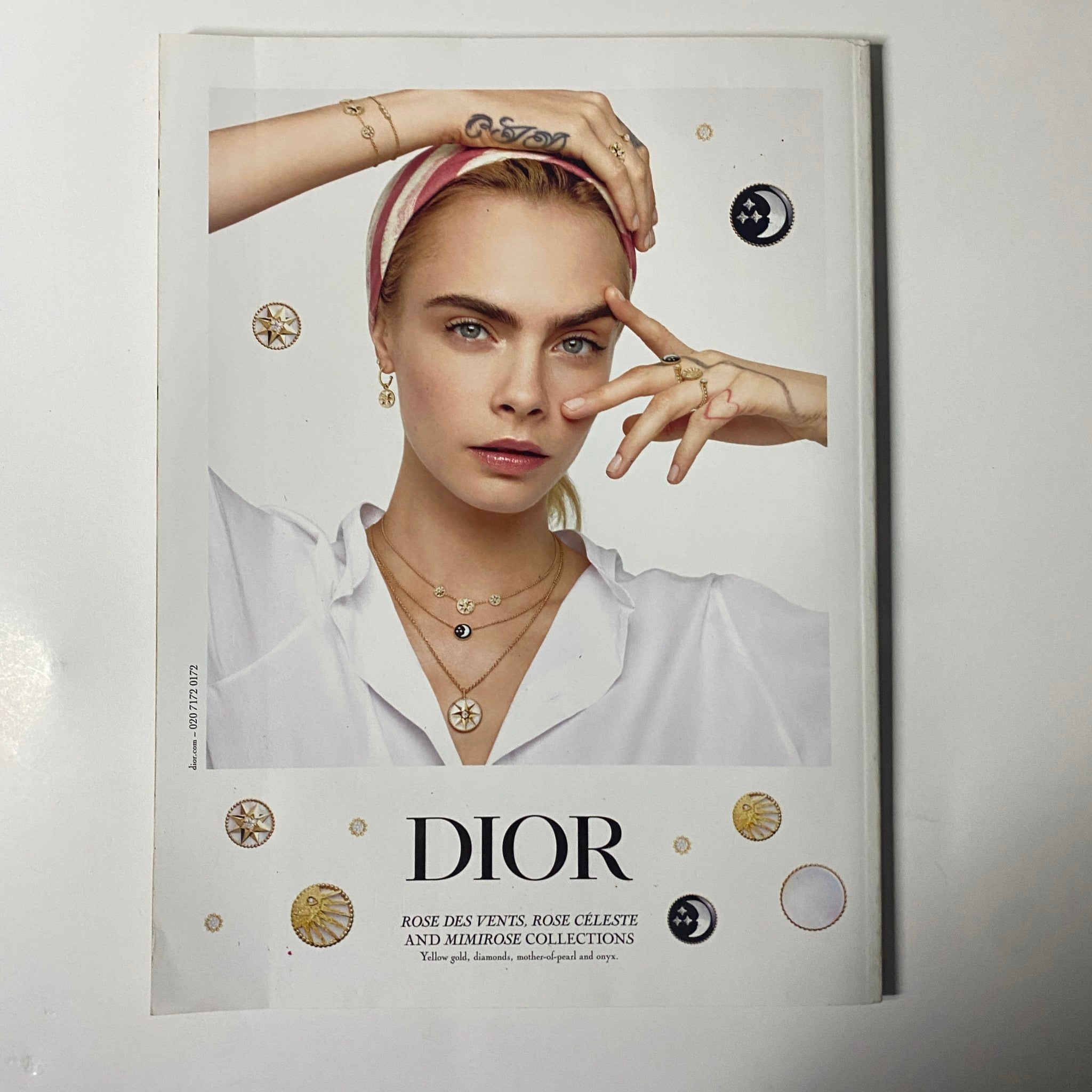 Harper's Bazaar UK Magazine August 2021 displaying an elegant DIOR advertisement featuring a model adorned with jewelry and a chic blouse, emphasizing luxury and sophistication in fashion.