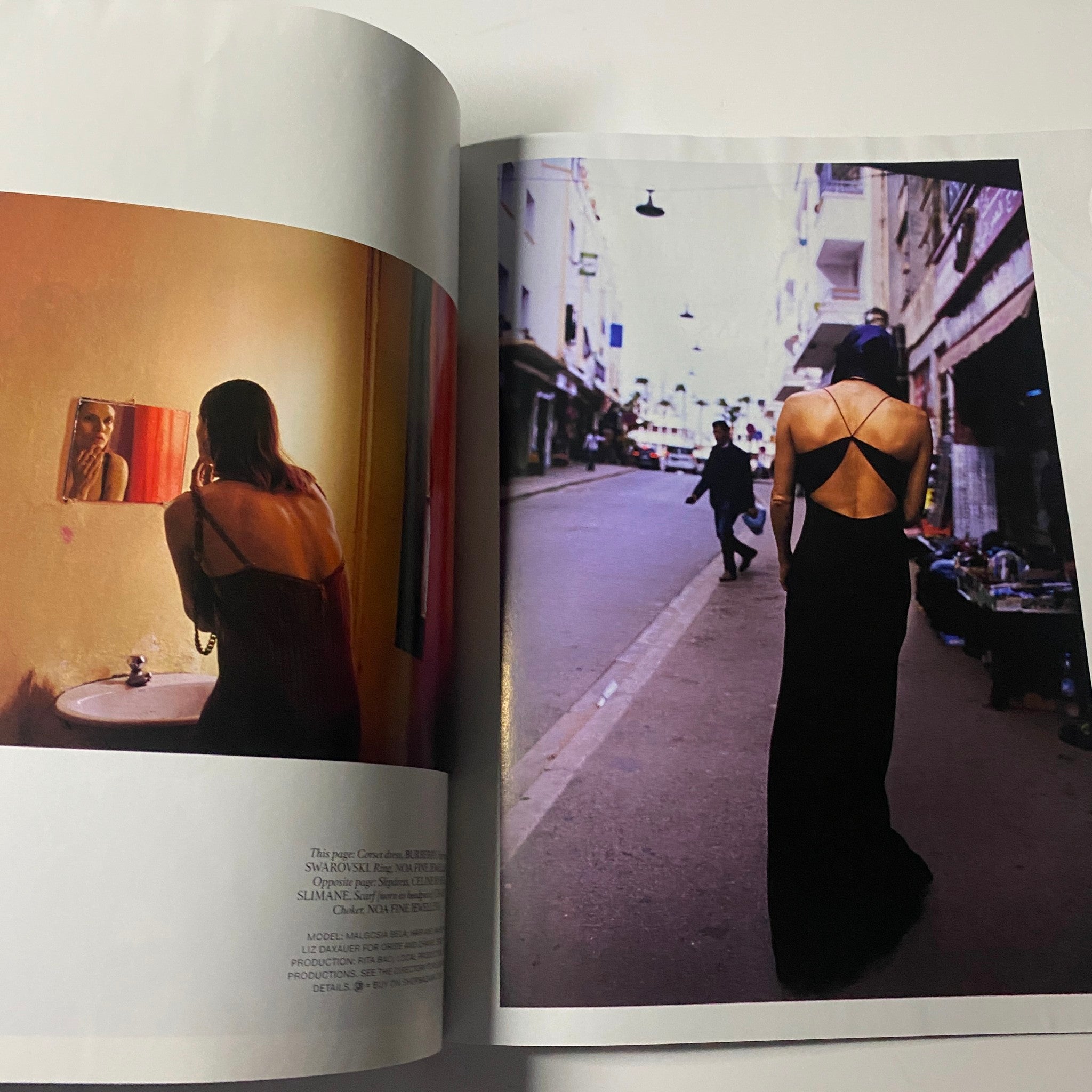 Interior pages of Harper's Bazaar Magazine August 2022, with a contrasting image of a woman wearing a black dress, reflecting themes of fashion and culture.