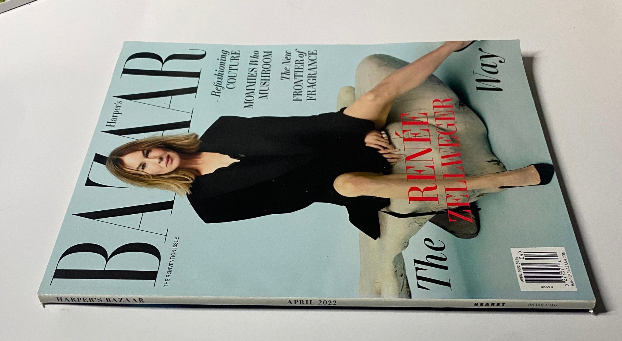 Another angle of the cover of Harper's Bazaar Magazine April 2022 with Renée Zellweger, emphasizing the magazine's artistic design and featuring articles like 'Mommies Who Mushroom' and fragrance insights.