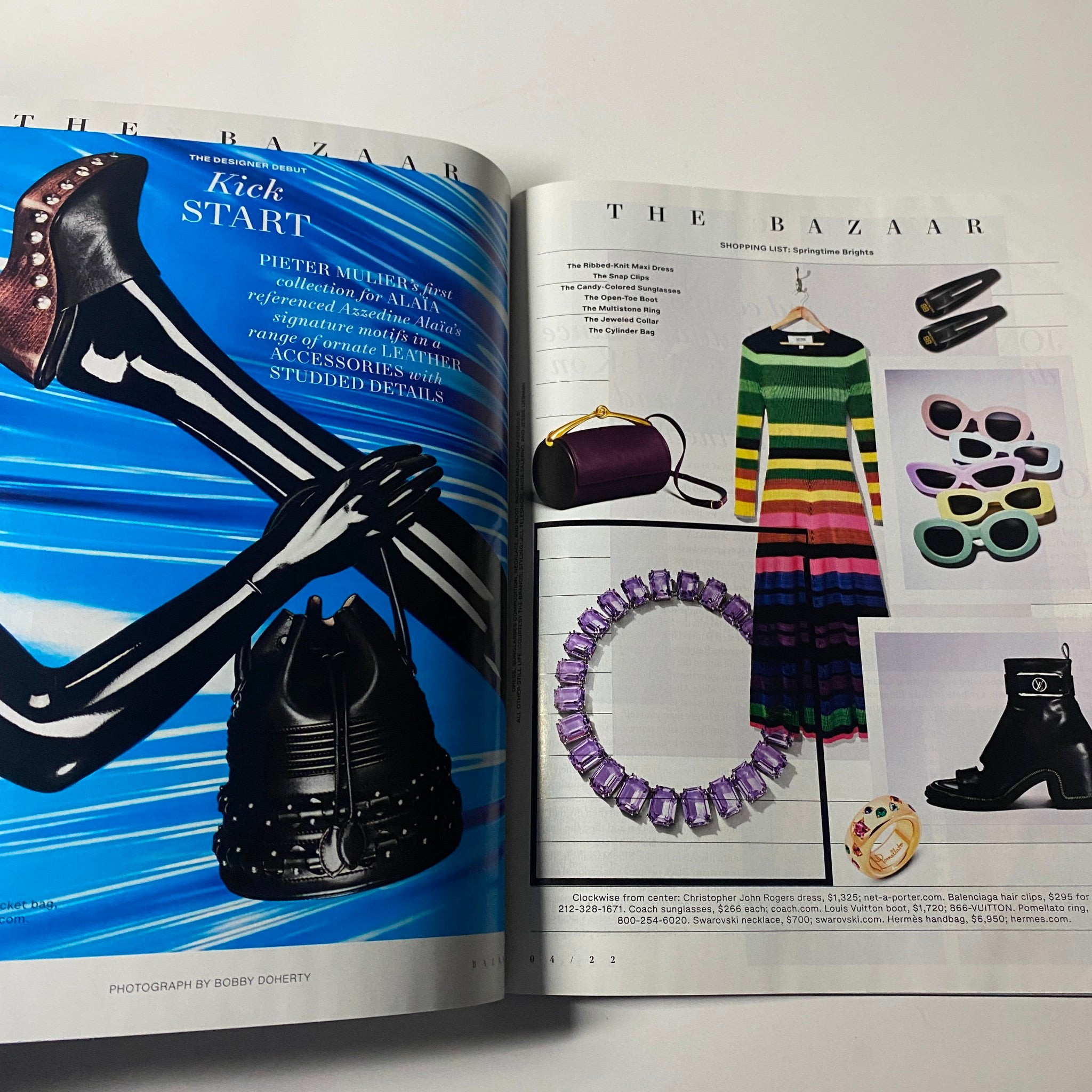 Fashion editorial spread from Harper's Bazaar Magazine April 2022 featuring bold accessories, a striped dress, and stylish accessories. Highlights creative styling in the issue with cover star Renée Zellweger.