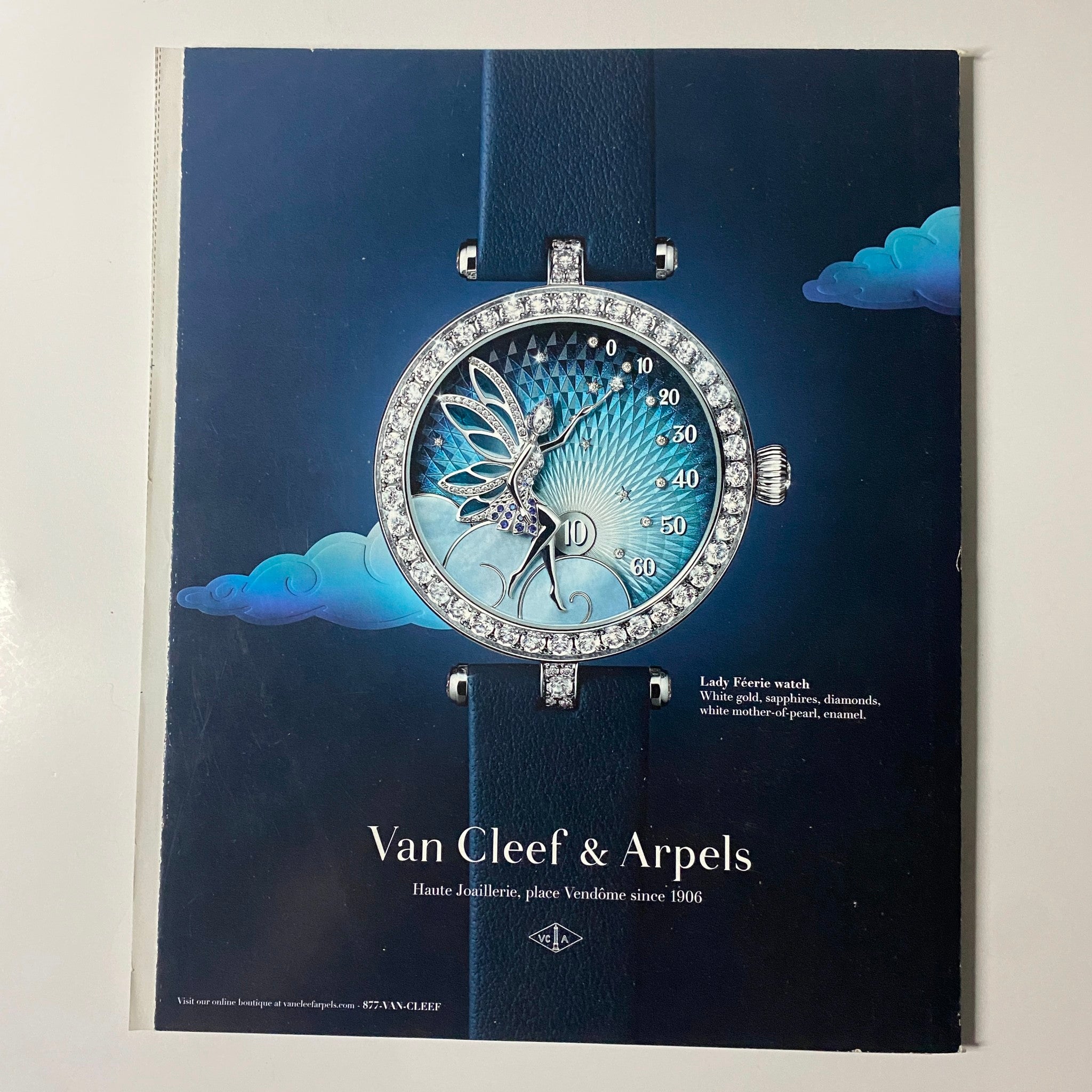 Van Cleef & Arpels advertisement showcasing a Lady Birds watch with intricate design against a serene background. Featured in Harper's Bazaar Magazine April 2022 with Renée Zellweger on the cover.