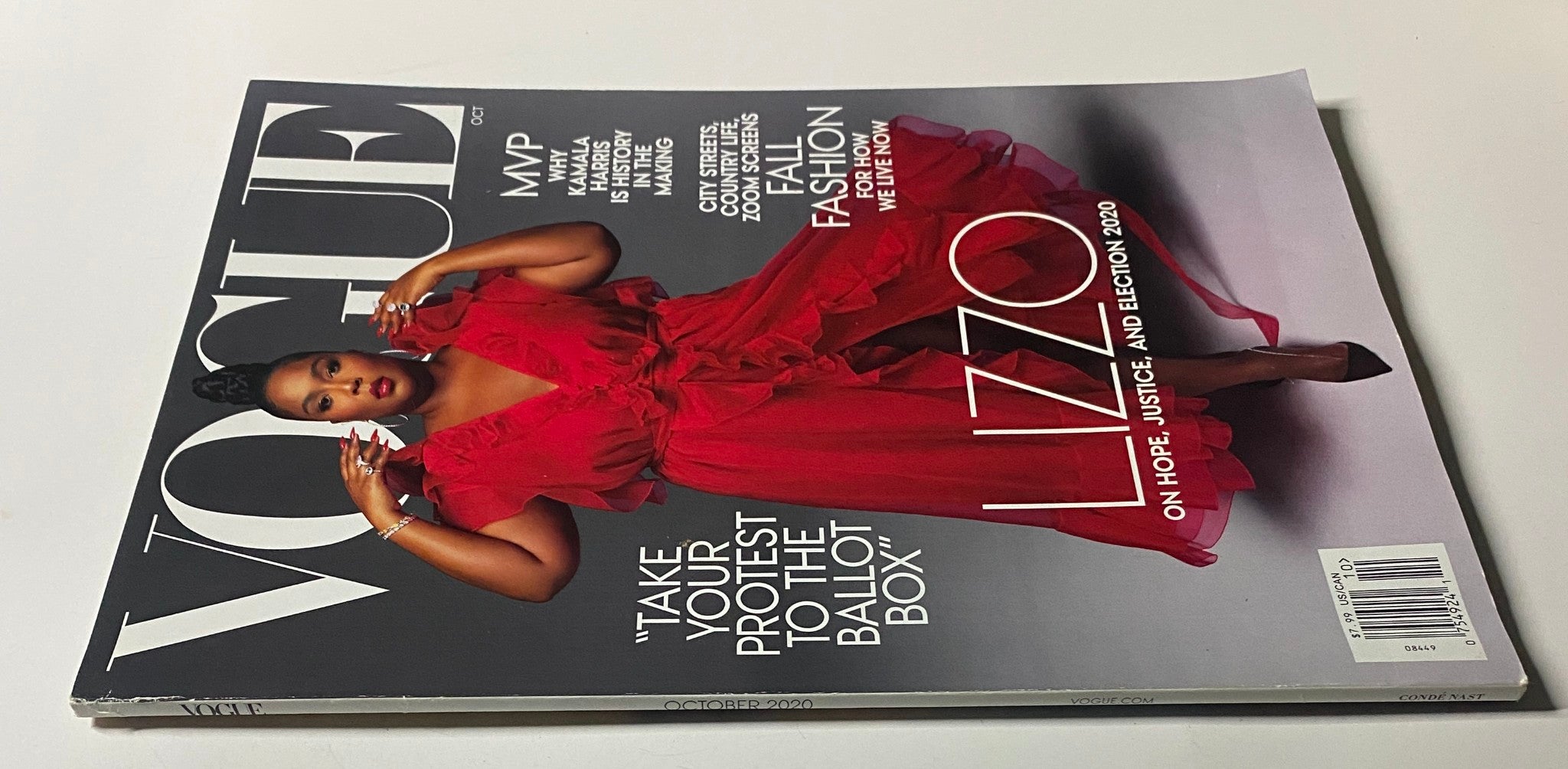 Close-up of the October 2020 Vogue Magazine Lizzo cover, emphasizing her bold red attire and call to action for voter participation.
