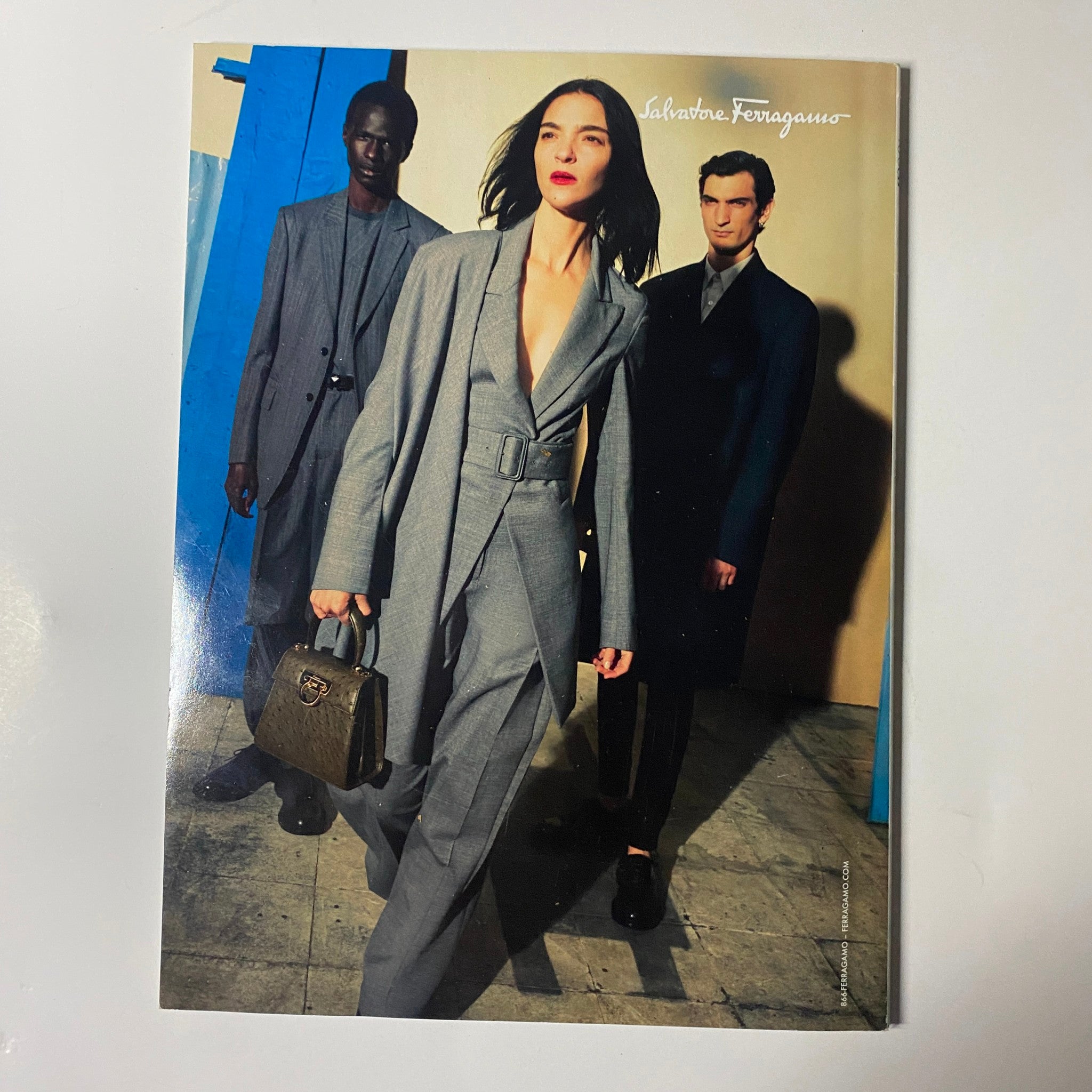 Vogue Magazine October 2020 showcasing a fashionable trio in sleek suits by Salvatore Ferragamo, exemplifying contemporary luxury and chic styling.