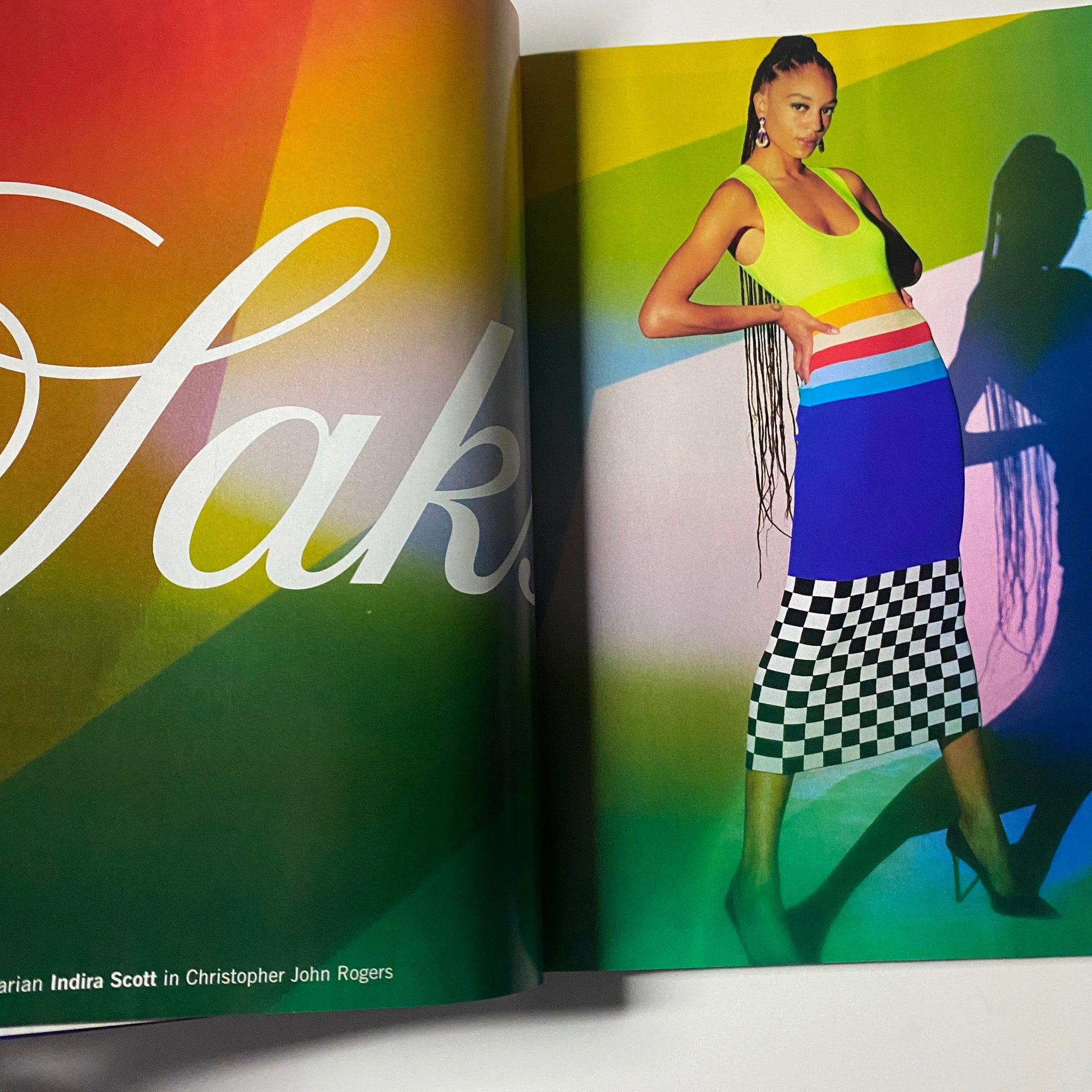 Fashion editorial page from Vogue Magazine March 2021, illustrating a colorful look with the theme 'Saks', showcasing bold designs and vibrant patterns.