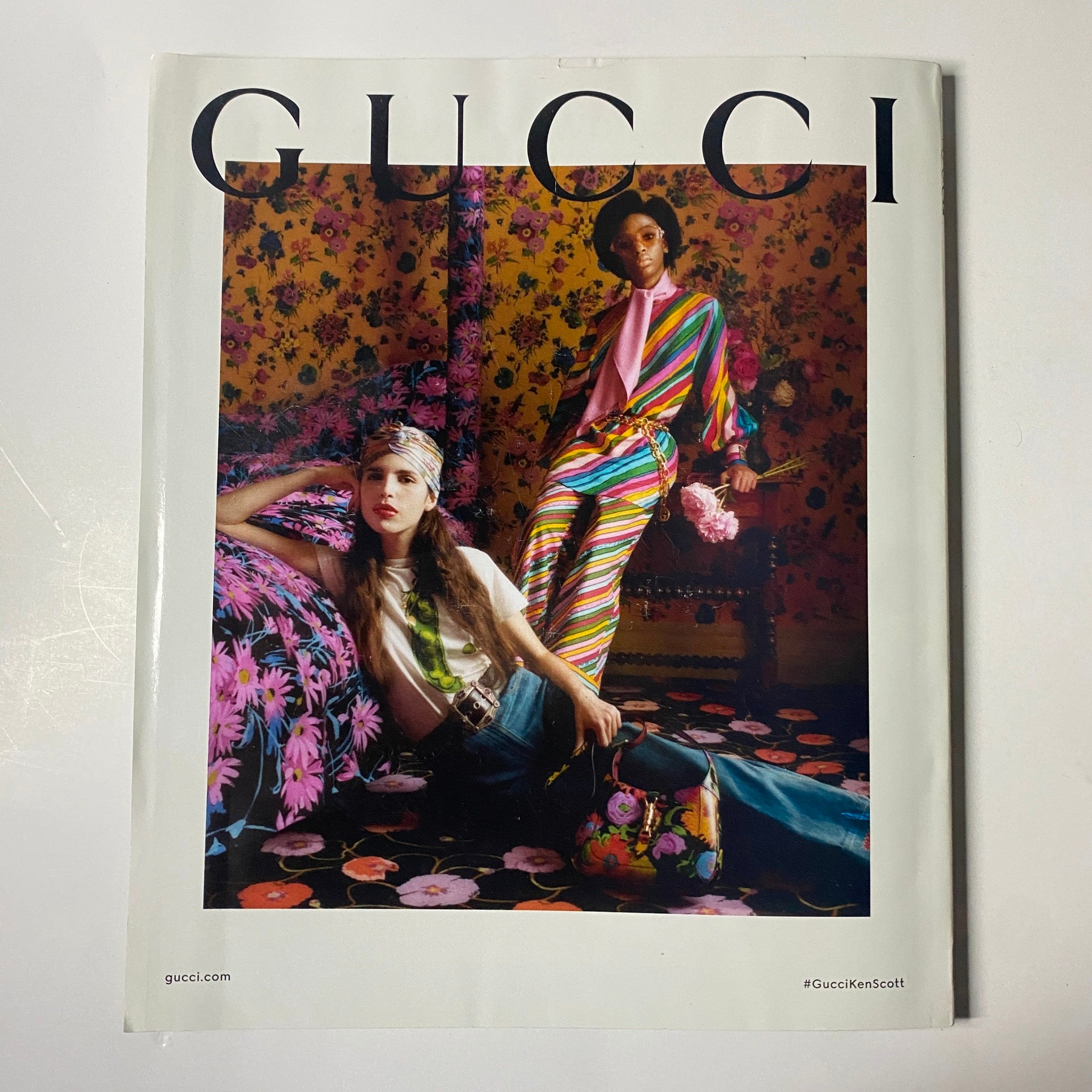 Vogue Magazine March 2021 Gigi Hadid Cover featuring a Gucci advertisement with models styled in vibrant floral patterns and bold colors.
